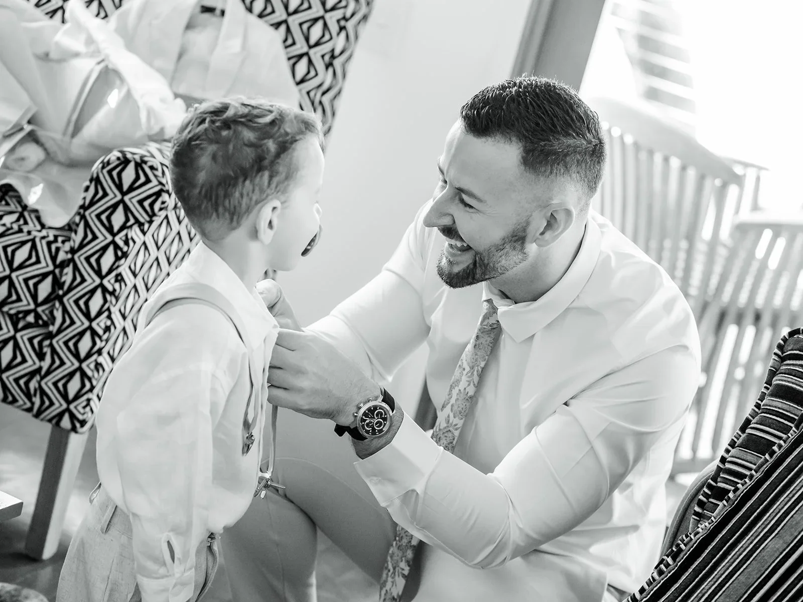 Groomsmen helping fasten cufflinks while getting ready in black and white — Sean Reefman Photography