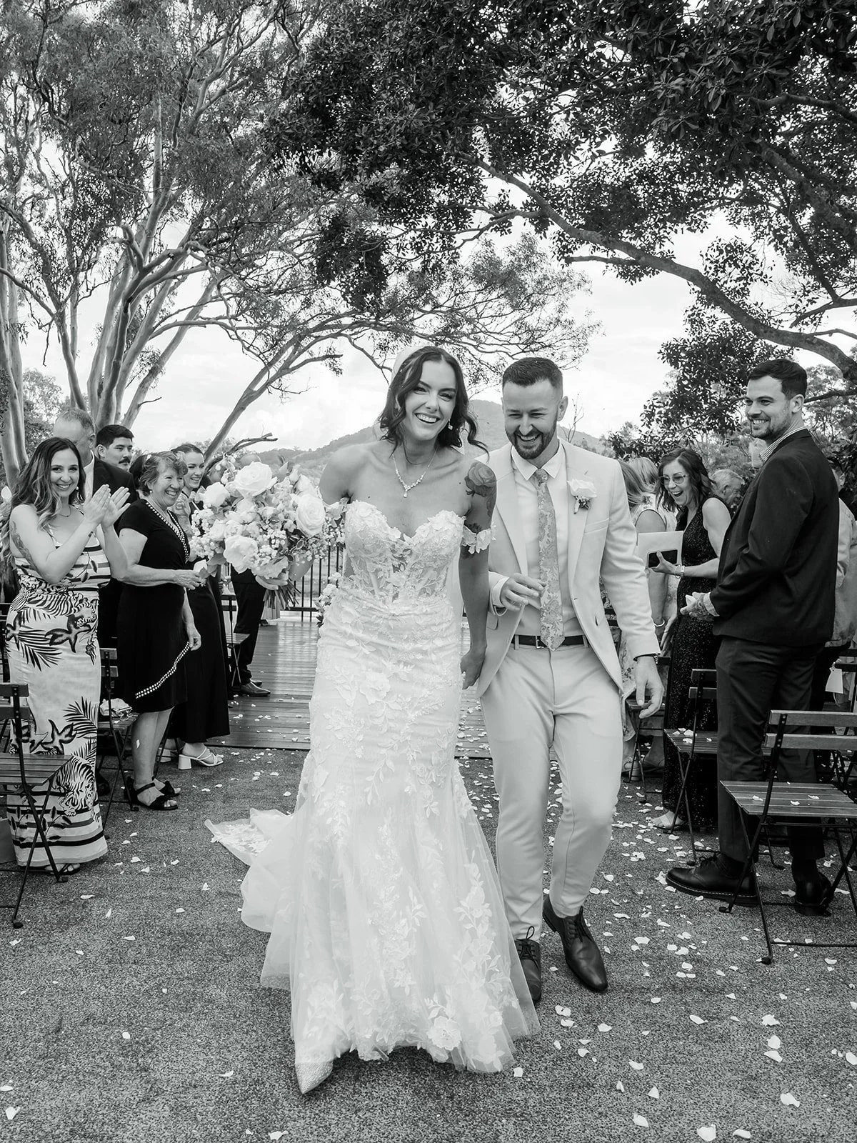 Chloe and James walking hand in hand smiling after the ceremony — Sean Reefman Photography