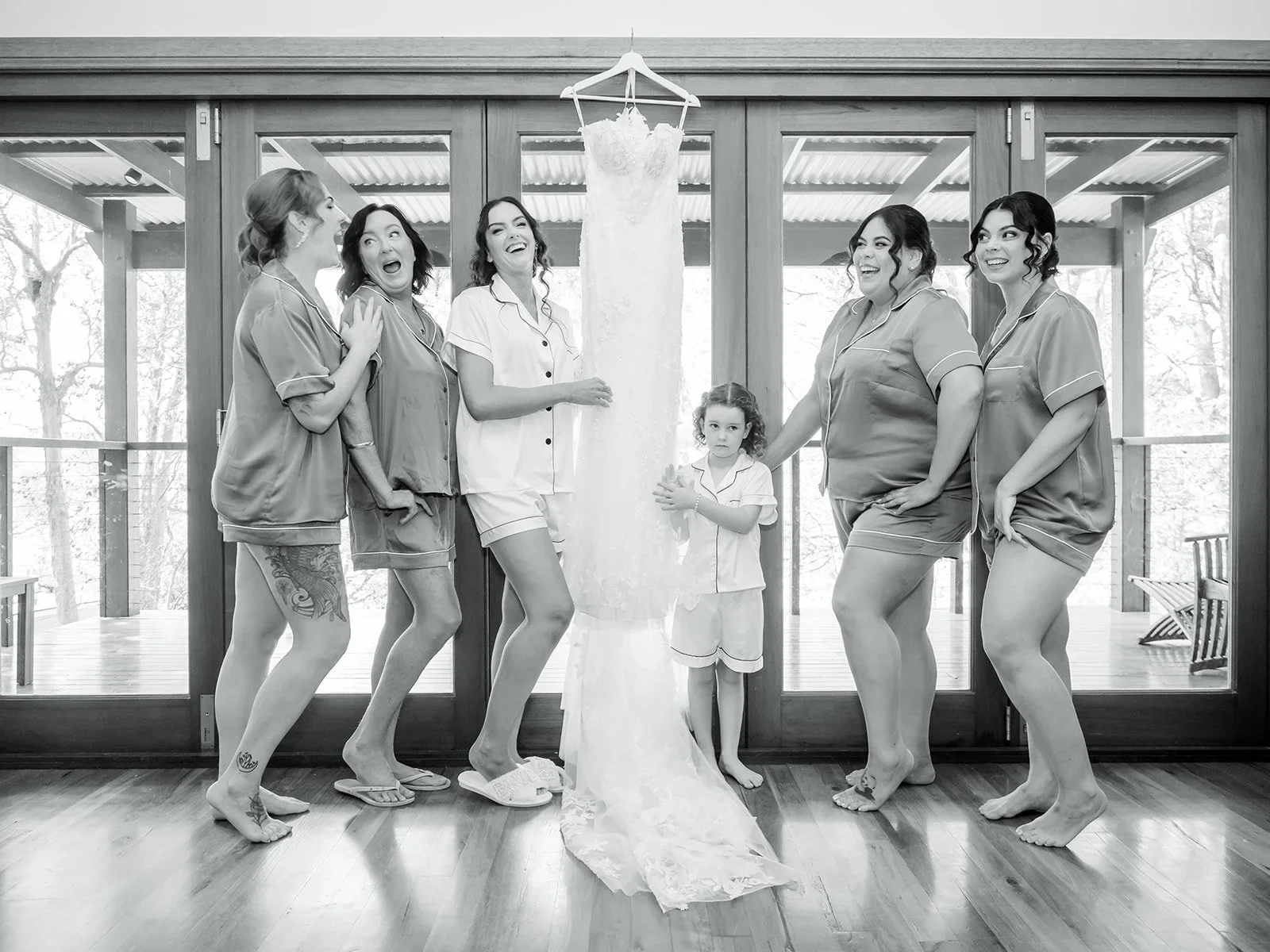 Bridal party laughing together in a black and white group portrait — Sean Reefman Photography