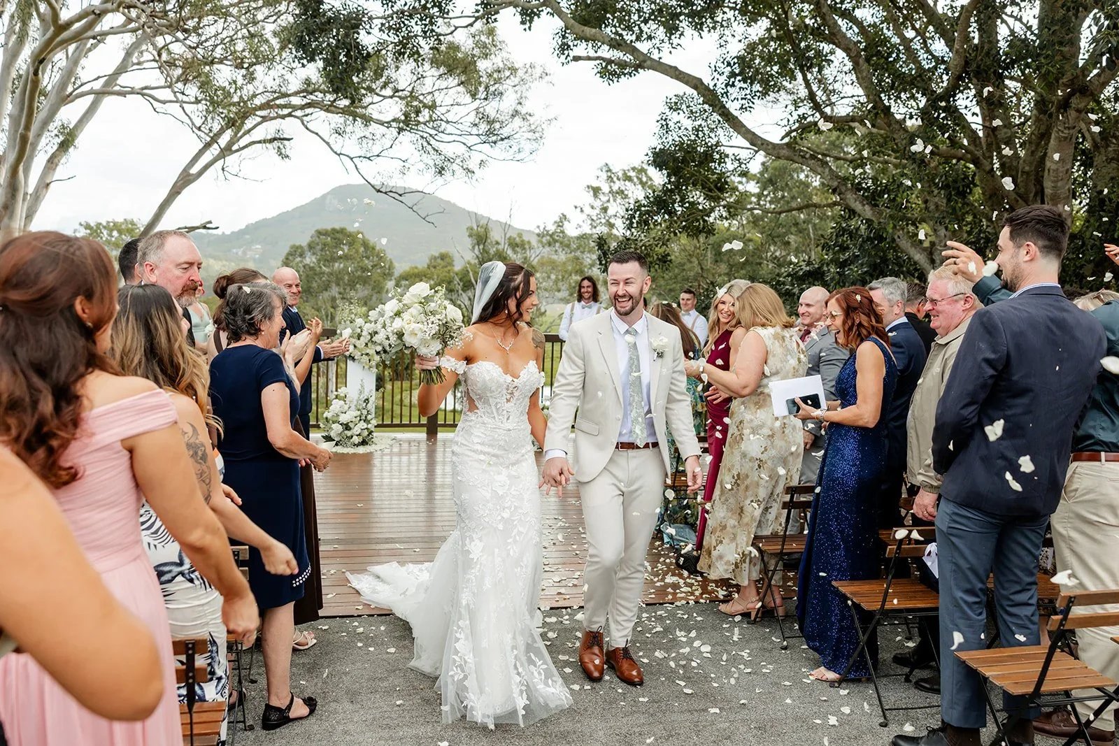 Wide view of the ceremony with bridal party and guests seated — Sean Reefman Photography
