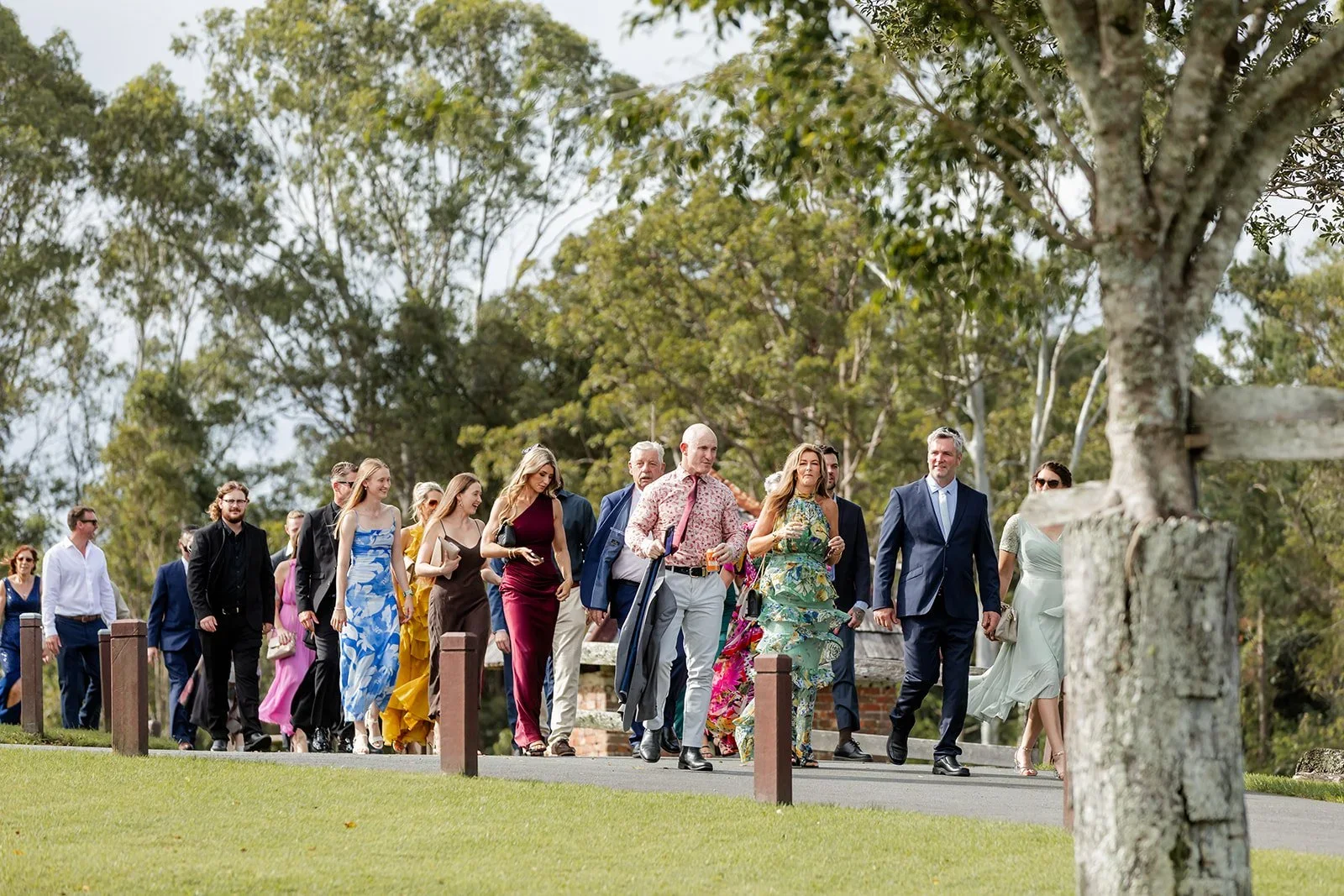Bridal party walking down the tree-lined path towards the ceremony — Sean Reefman Photography