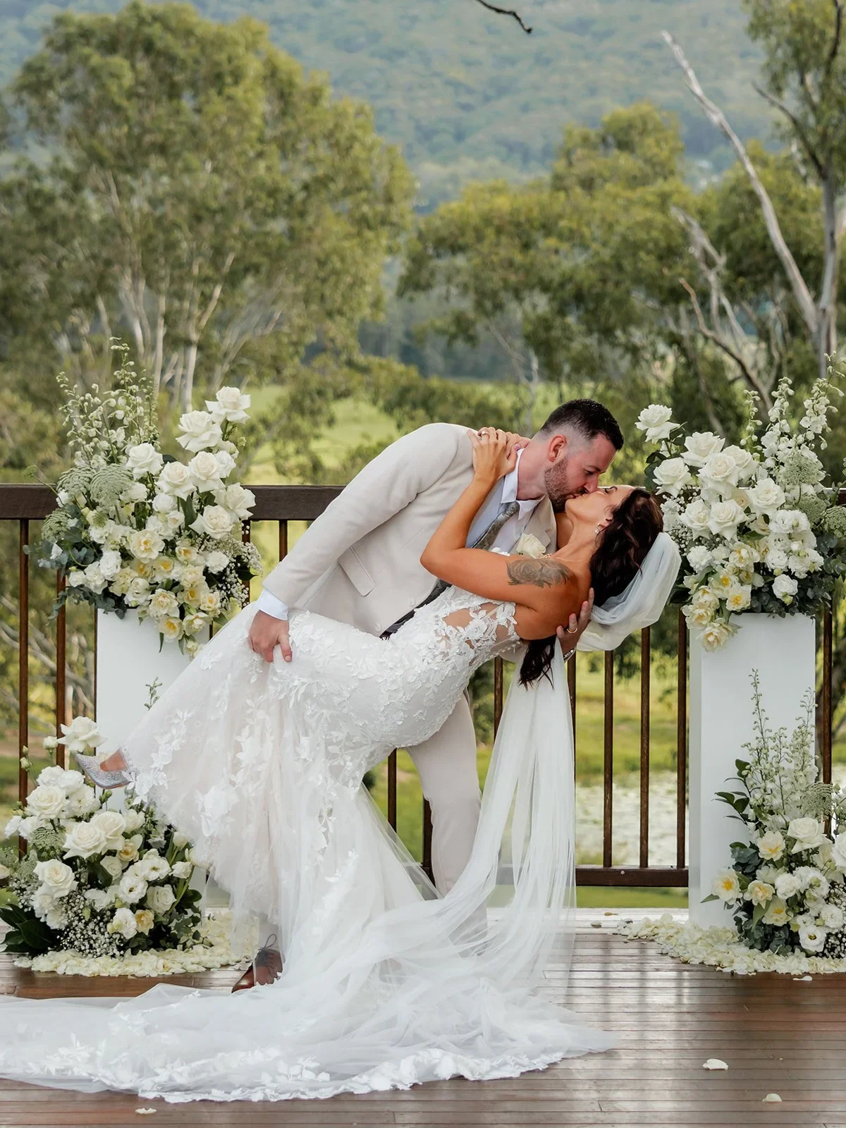 James dipping Chloe for a kiss under the ceremony arch — Sean Reefman Photography