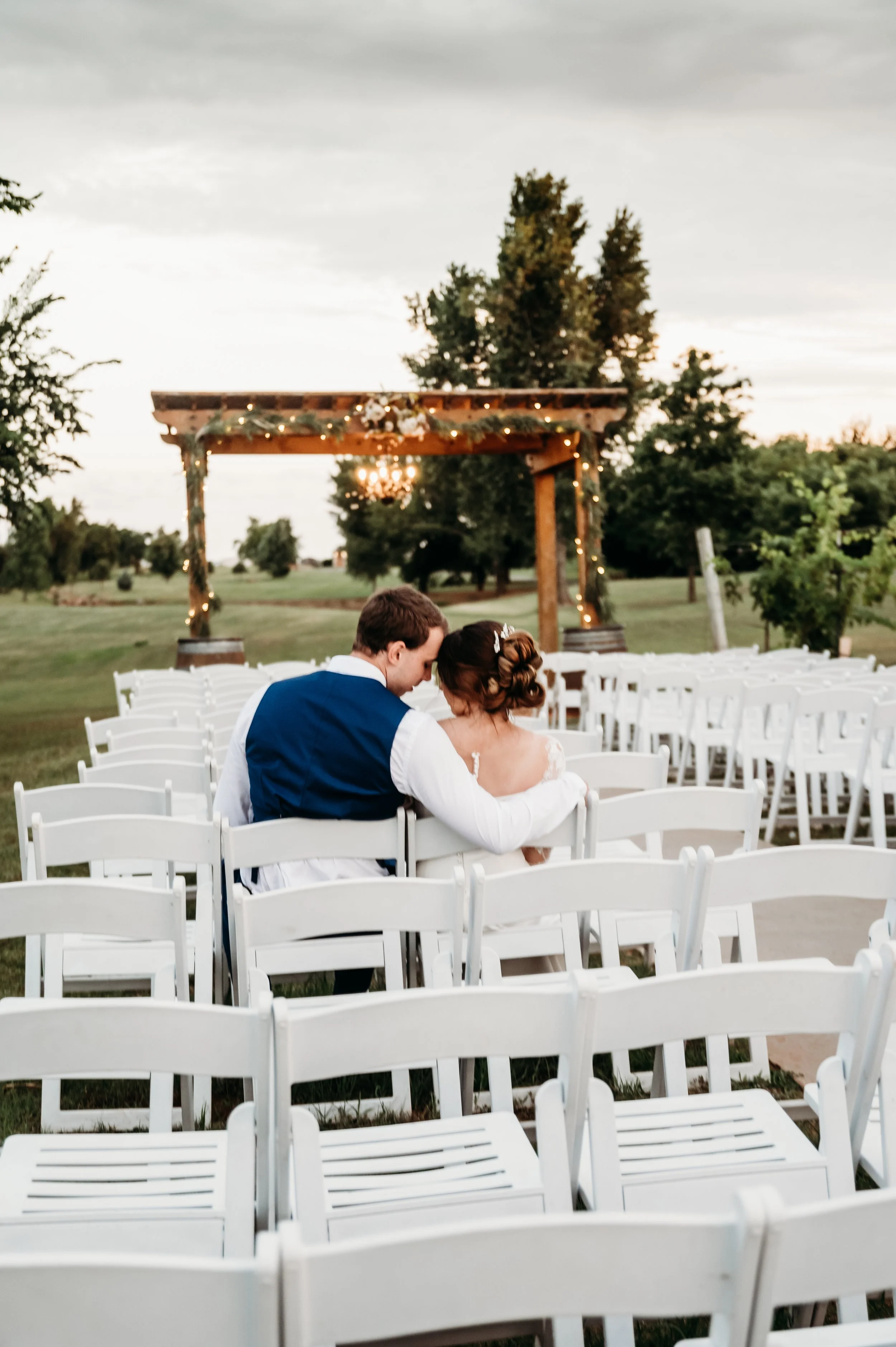 Clauren ridge winery couple sitting in seats wedding photographer Oklahoma