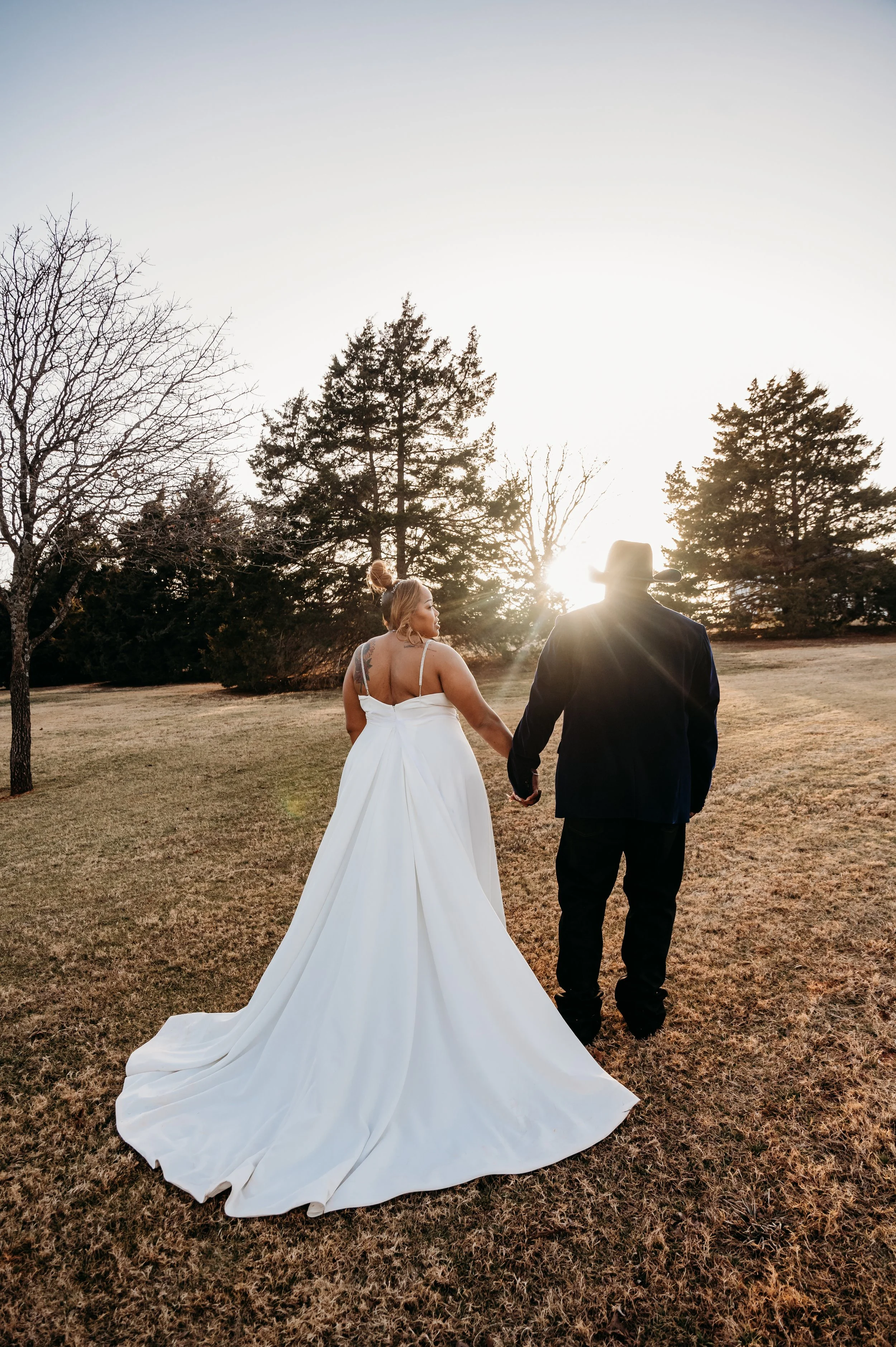 Esperanza ranch wedding, photographer, couple, looking at camera and walking into sunset