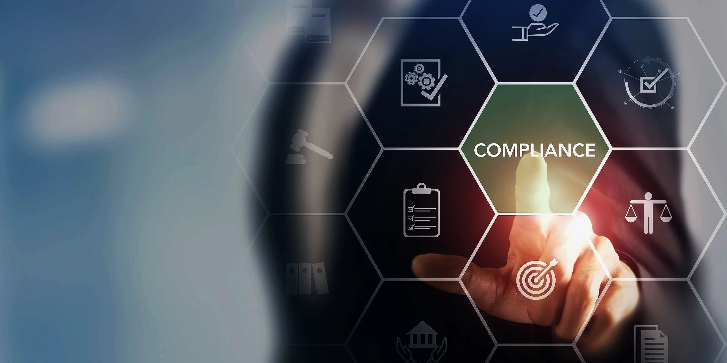 Businessman touching digital compliance icon with hexagonal graphics representing legal and regulatory symbols.