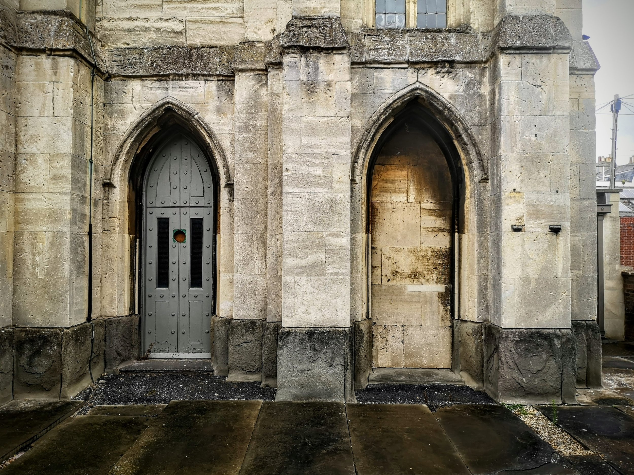 Neither door here is in use. One is blocked, the other simply locked. Trinity Church, Cheltenham