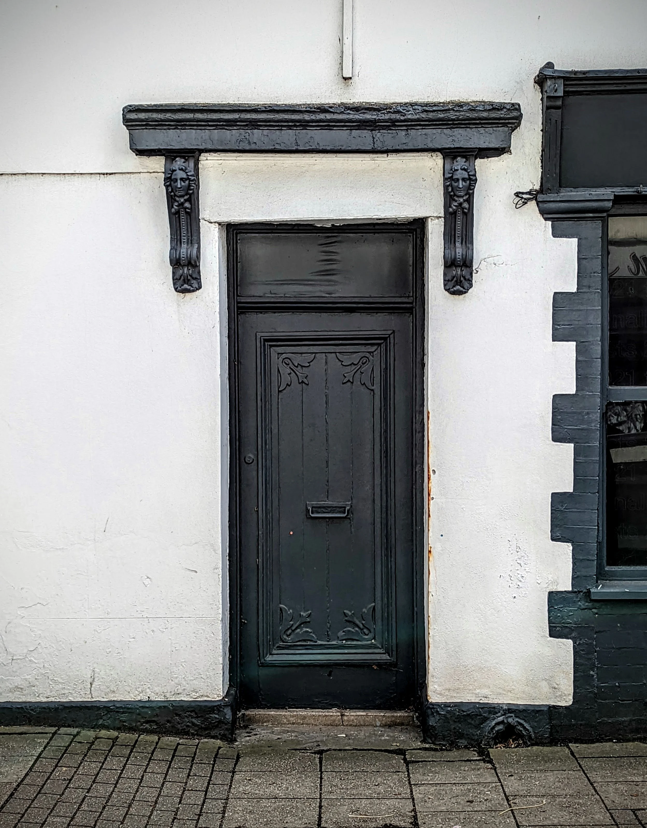 Lovely example of a paint-over, door features visible but everything covered in thick black paint. Caroleon, Wales