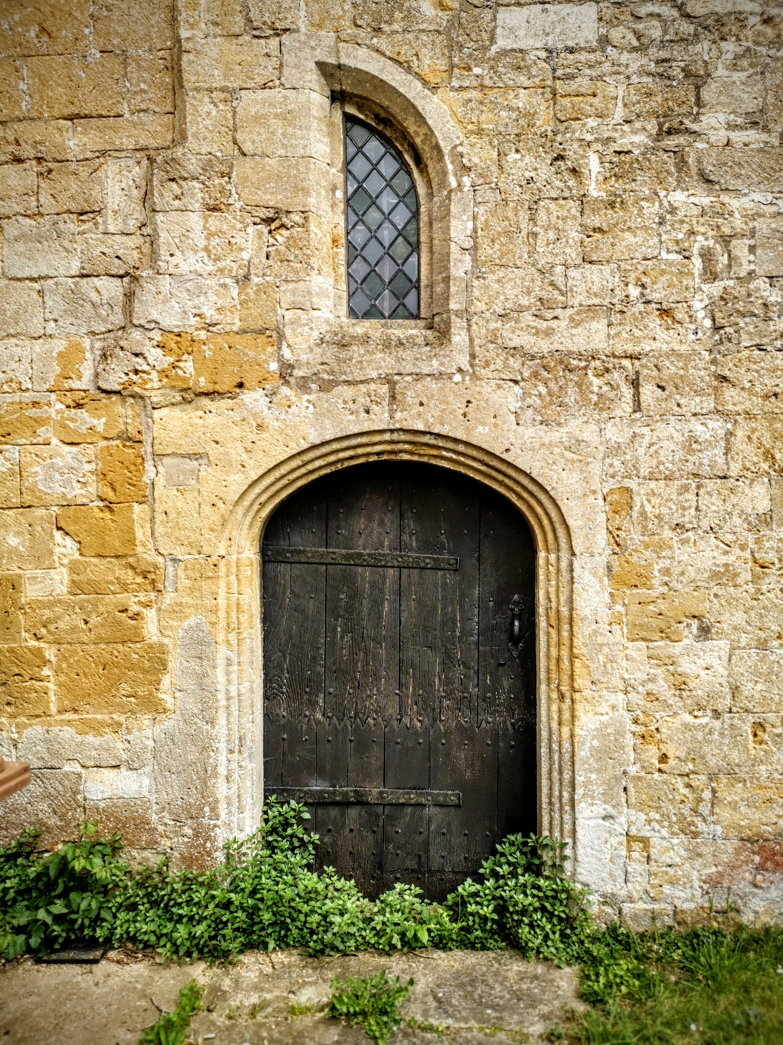 Inside this door is boarded up and has chairs stacked against it. Love the half window above. St Michael's, Buckland
