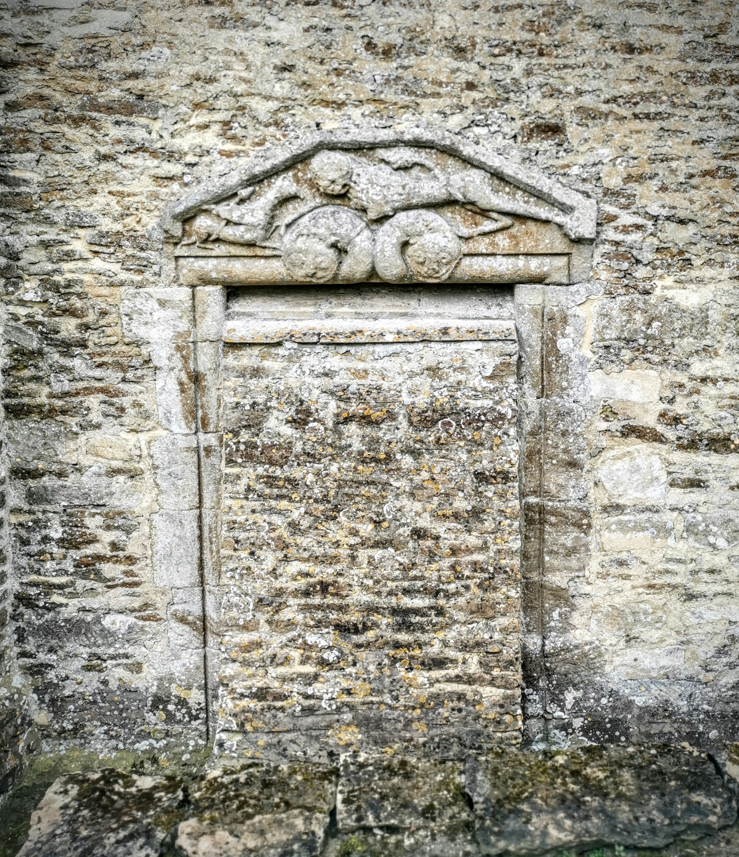 Incredible blocked door in Ampney St Marys, with a rare Norman tympanum featuring a lion and griffon (good) defeating a twin-headed serpent (evil). 