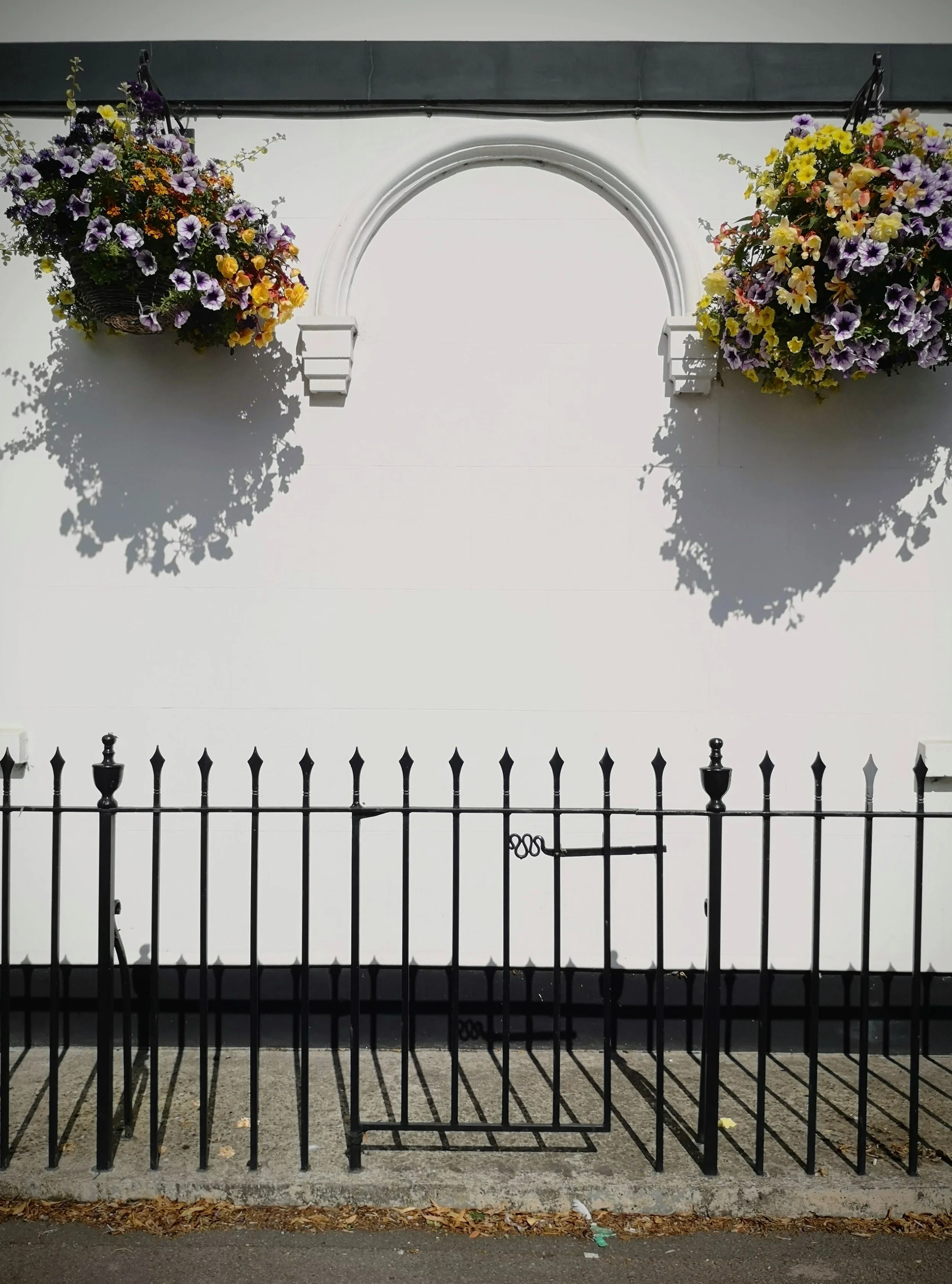 I jokingly refer to this as 'patient zero'. It is a ghost door's final form, only the curved pediment and the gate in the fence in front show there was ever a door once here