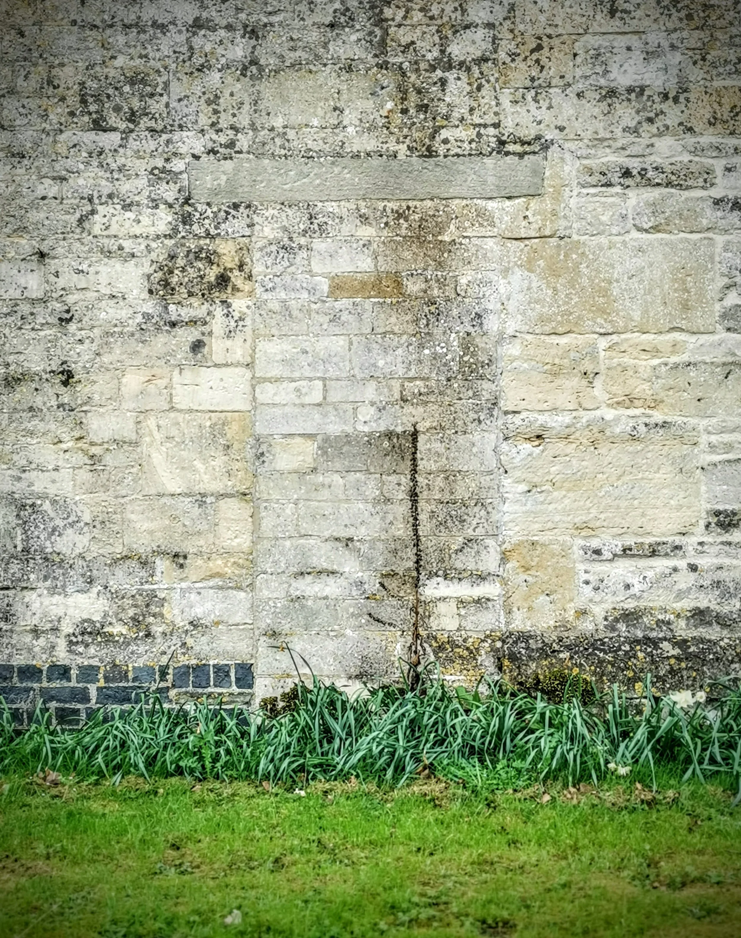 Barely there ghost door in the Cotswold stone of Coberly