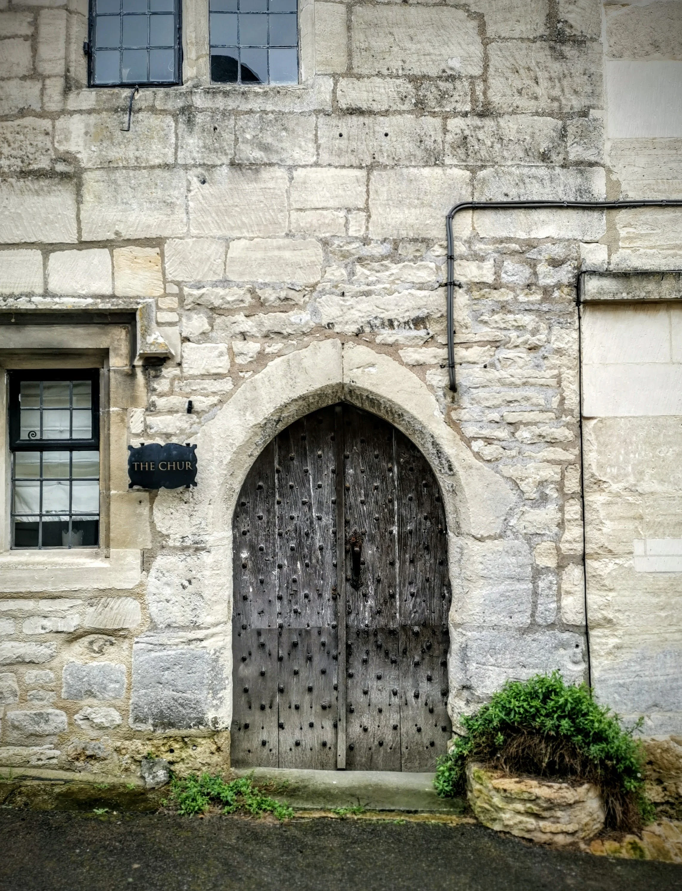 The doors were robust, studded with iron and made of heavy oak