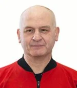 A bald man wearing a red and black sports jacket
