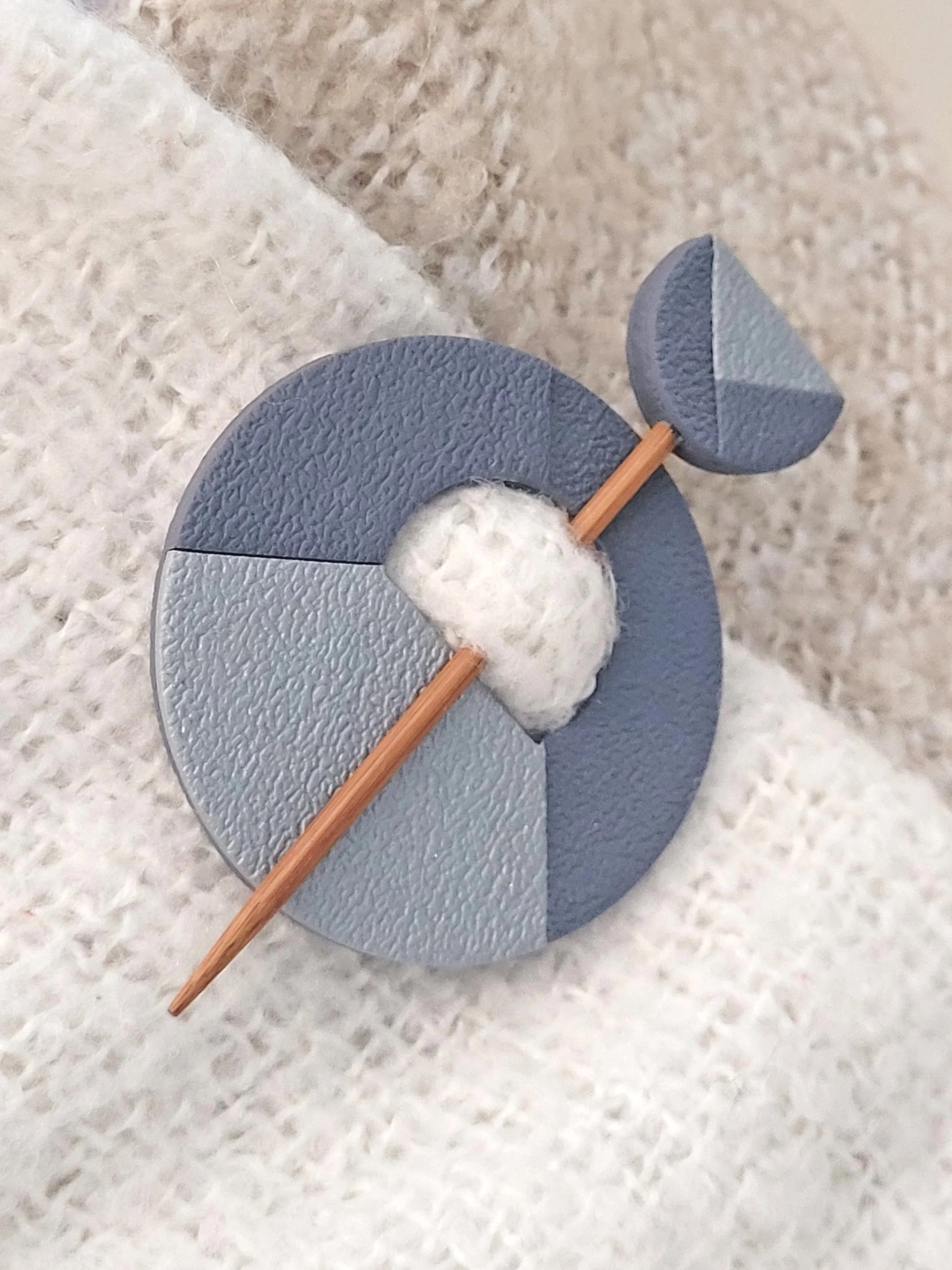 The Two Tone Grey pin features a metallic silver left quadrant and two cut layers of the darker grey tone.