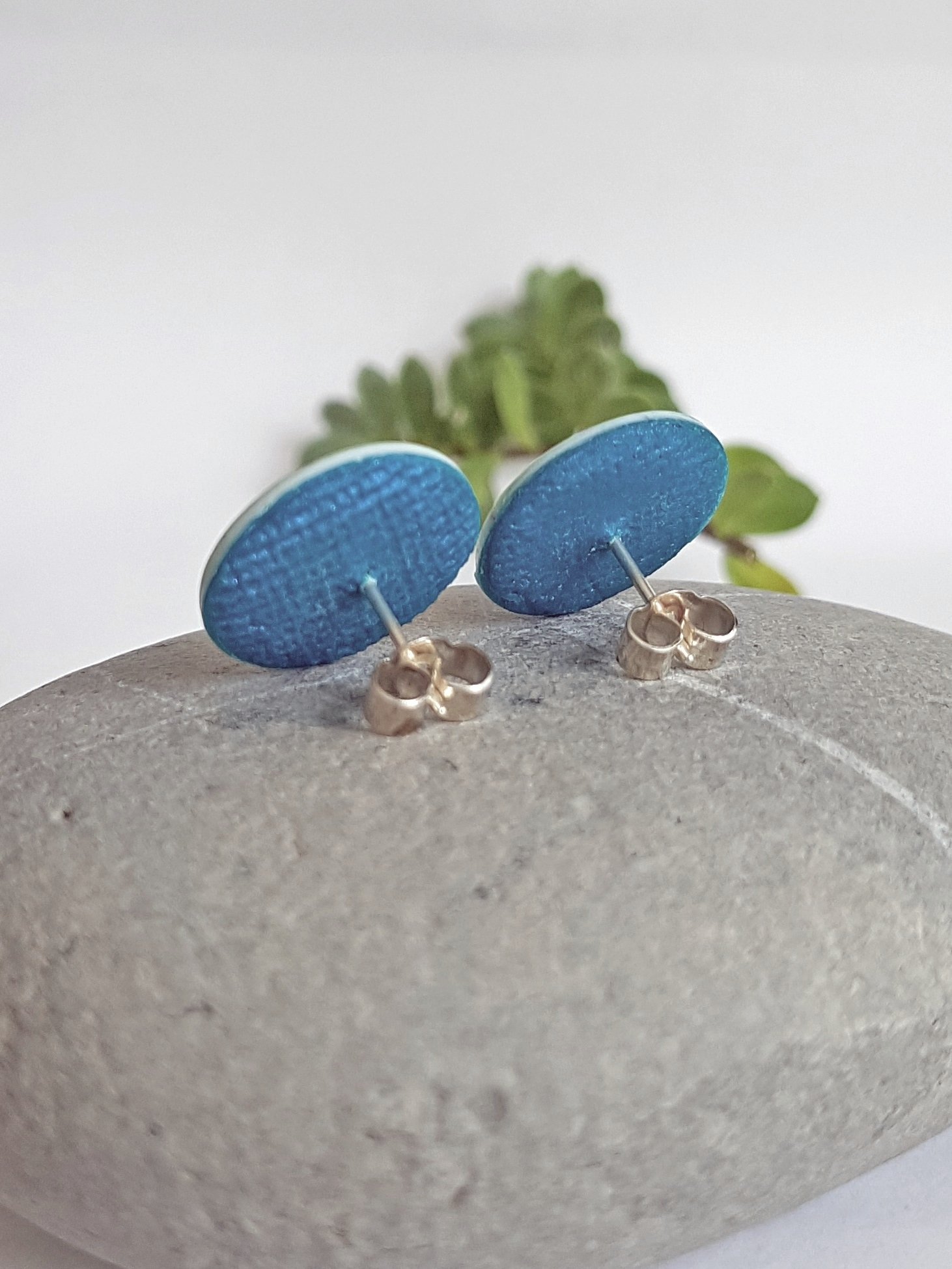 Back of Kalamata stud earrings with textured blue clay and sterling silver posts and scrolls.