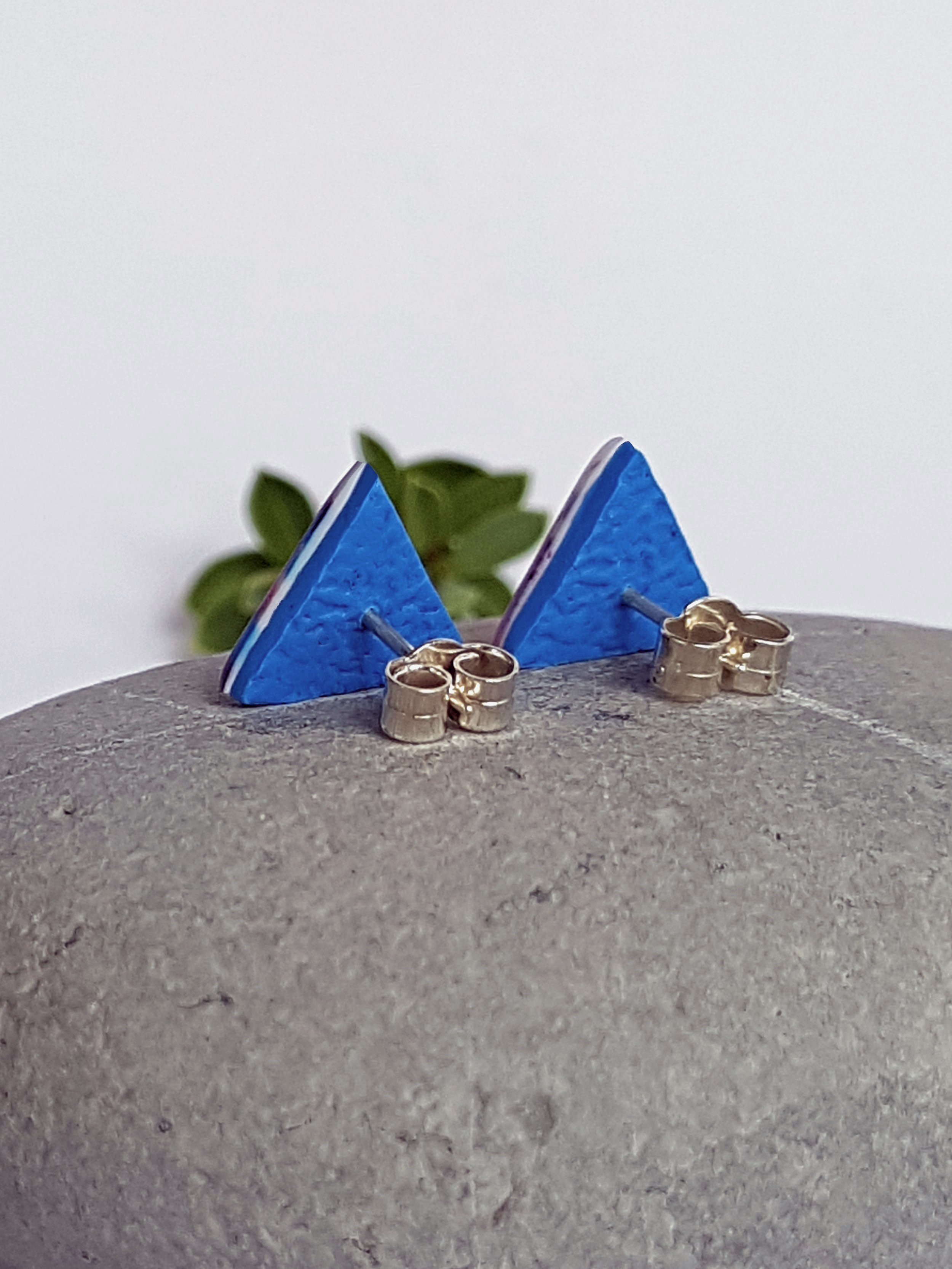 Lightweight, smooth, flat, red, white and blue triangular stud earrings with bright blue backs and sterling silver posts and scrolls.