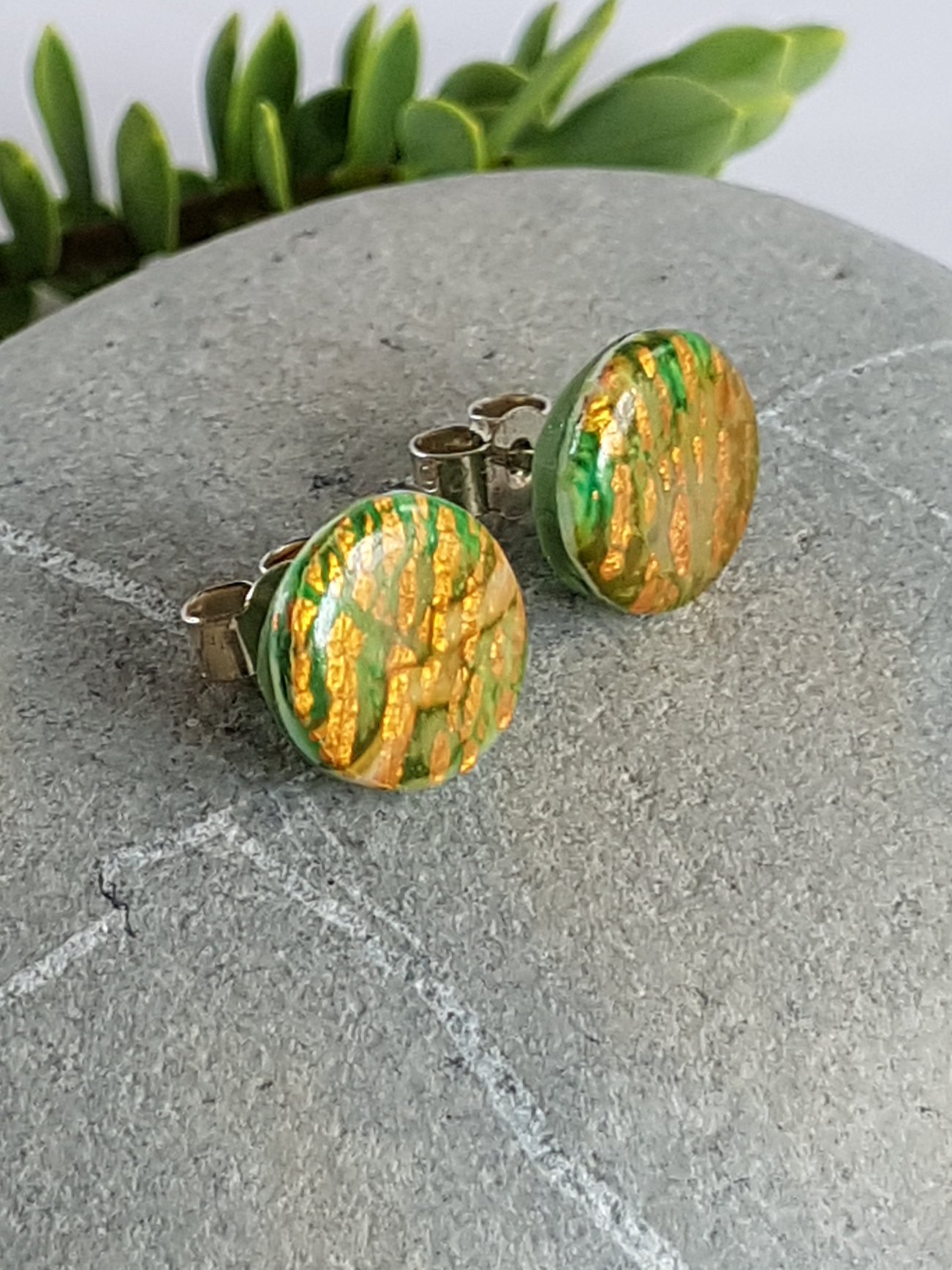 10 mm diameter round green stud earring with broken diagonal lines of faux gold leaf on the face.