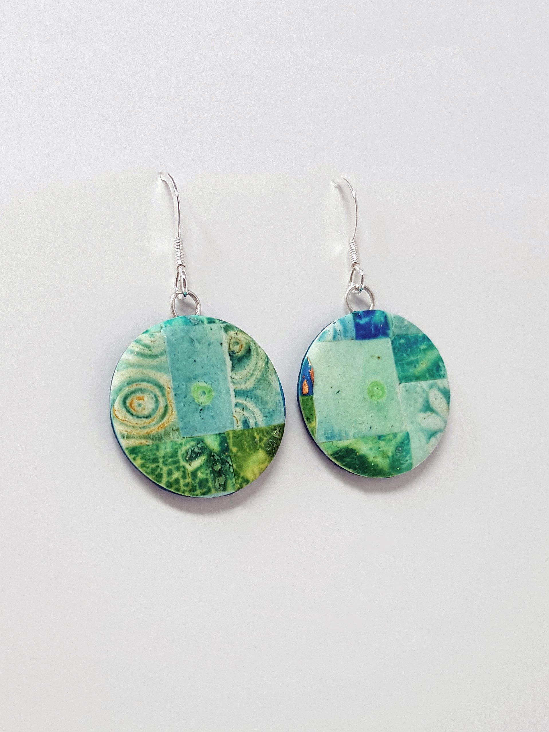 Tiny mosaic tiles with abstract circles, flower and mottled patterns in green, turquoise, blue round, flat bead earrings.