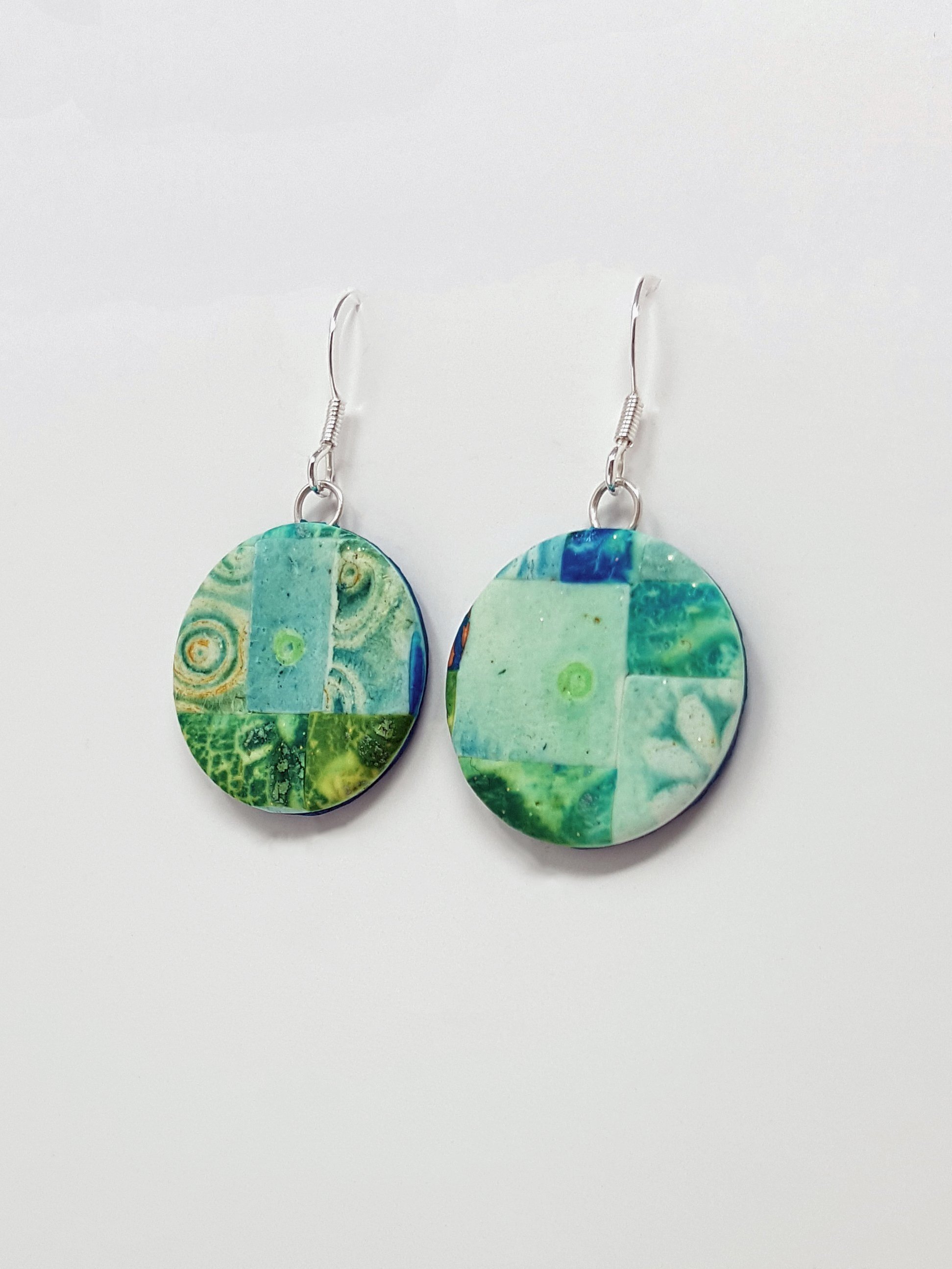 Irregular mosaic pattern on round disc beads in turquoise, blue, green, with sterling silver ear wires.