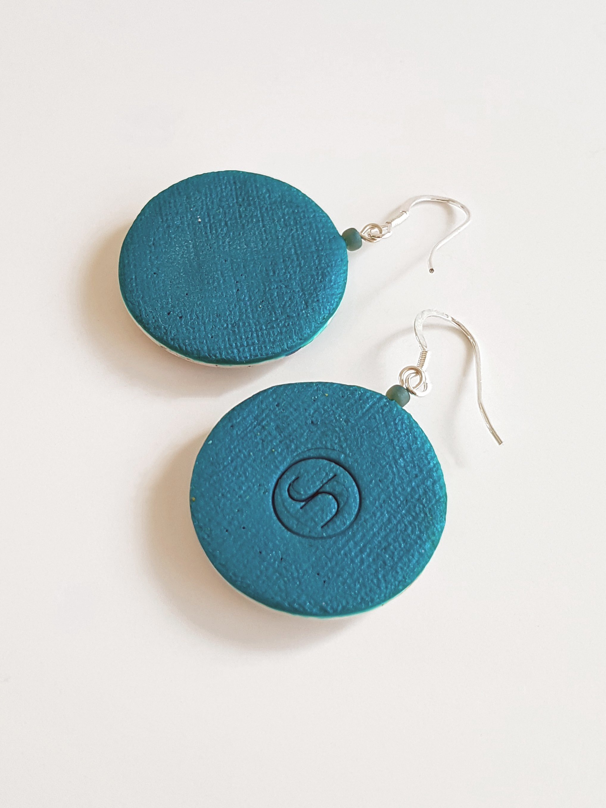 Teal backs of Kalamata Bands earrings, one stamped with makers mark, sterling silver ear wires.