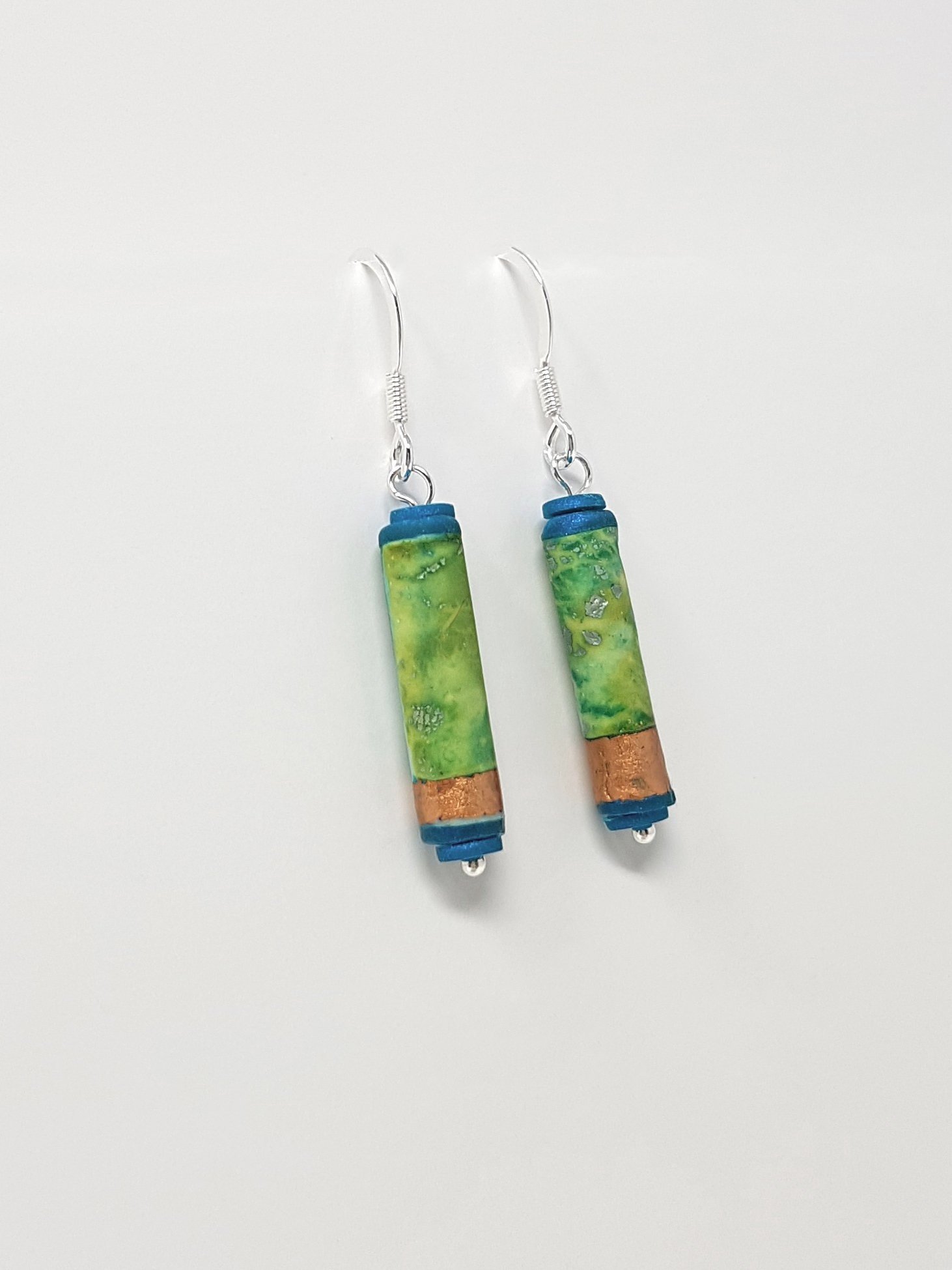 Boho style polymer clay tube dangle earrings with mottled green and turquoise, faux bronze leaf bands, teal tube ends, silver ear wires.