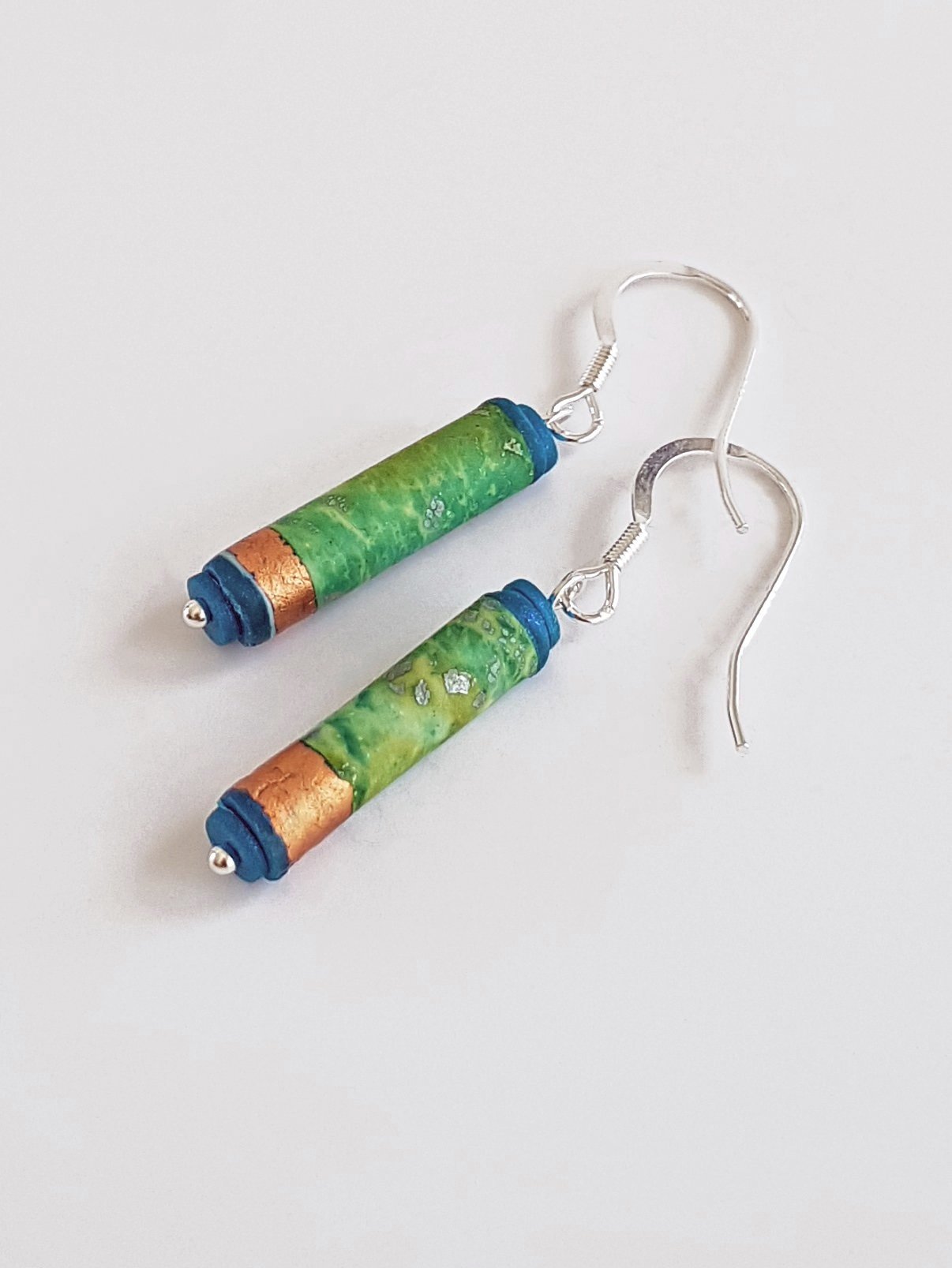 Tube earrings with distressed boho mottled green blue surface, teal ends, sterling silver wires.