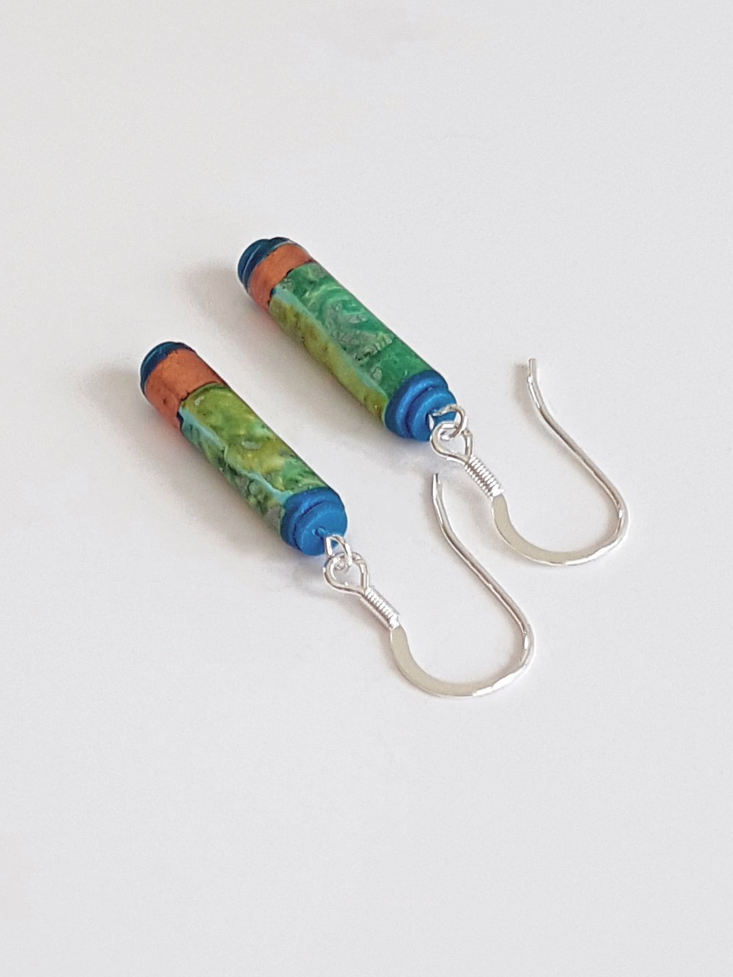 Sterling silver ear wires in green, blue, turquoise tube beads with faux bronze leaf bands and teal end caps.