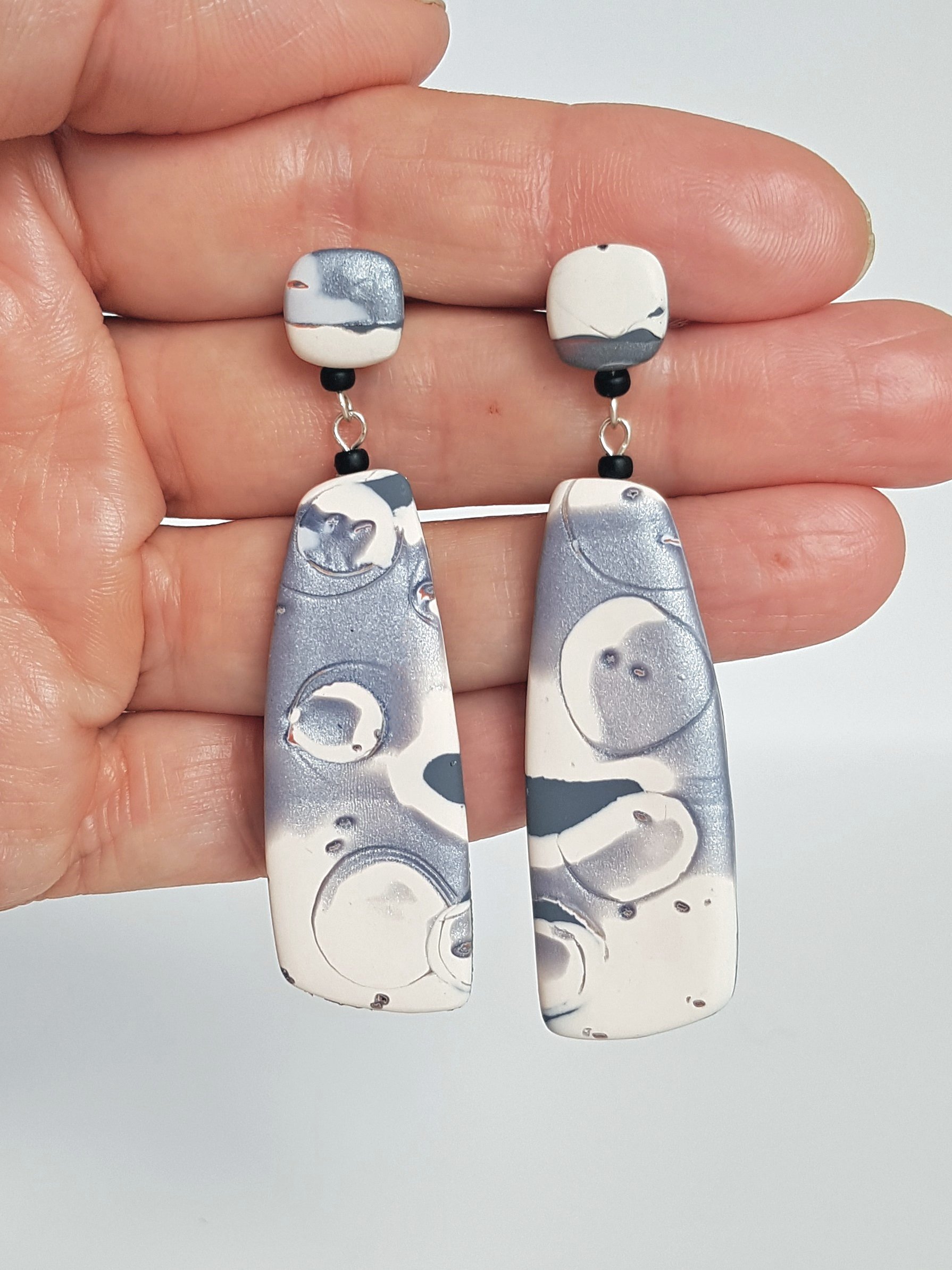 Nimbus Tablets held between fingers to indicate the size