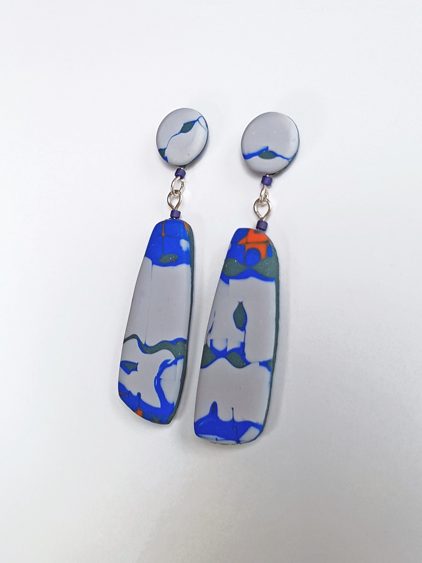 Grey stud and drop earrings with a mismatched graphic pattern in red, green and blue, with sterling silver posts and scrolls.