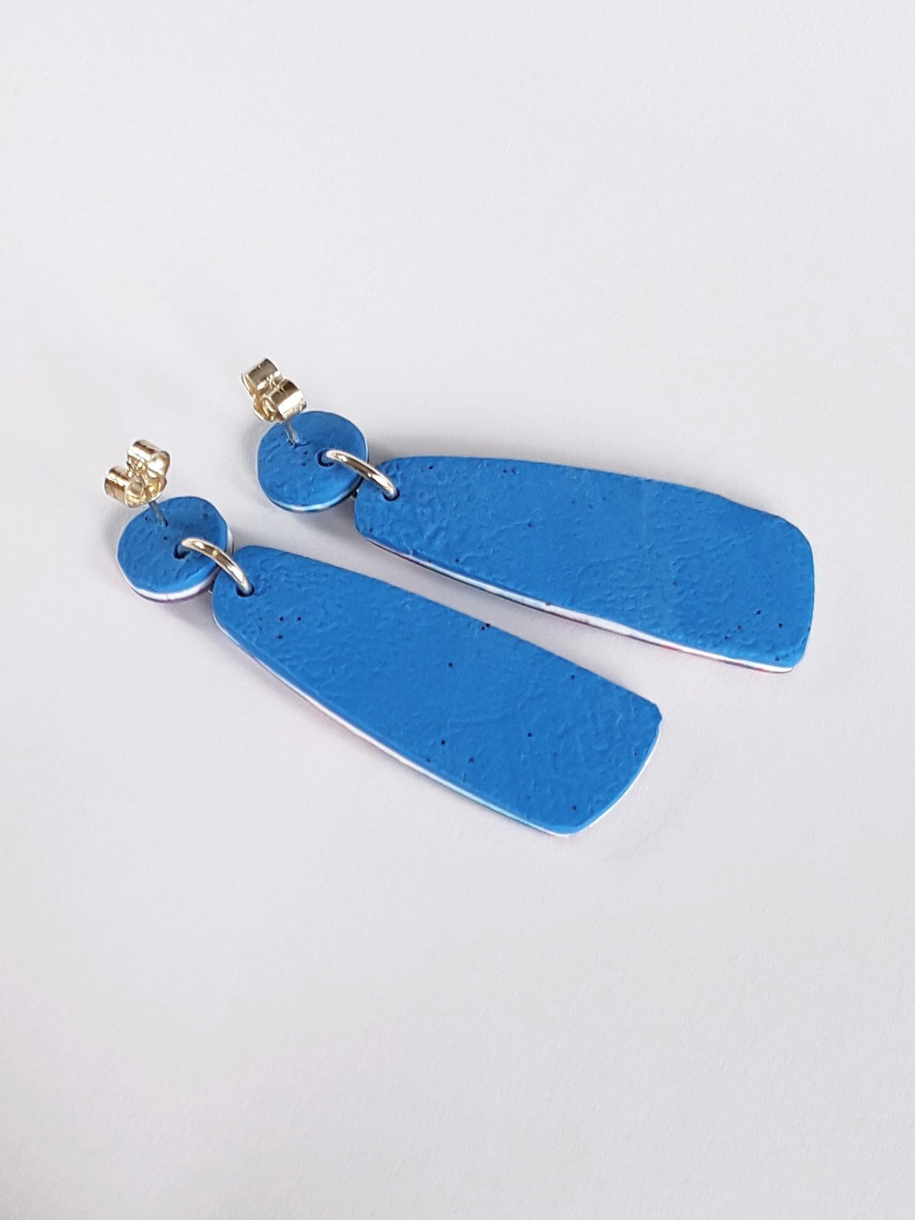 Back of Moonlight Earrings with bright blue textured clay and sterling silver posts and scrolls