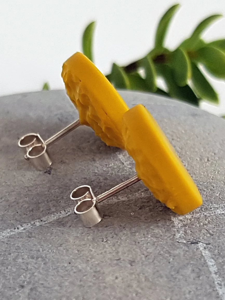Mustard round stud earrings with lightly textured backs and sterling silver posts and scrolls.