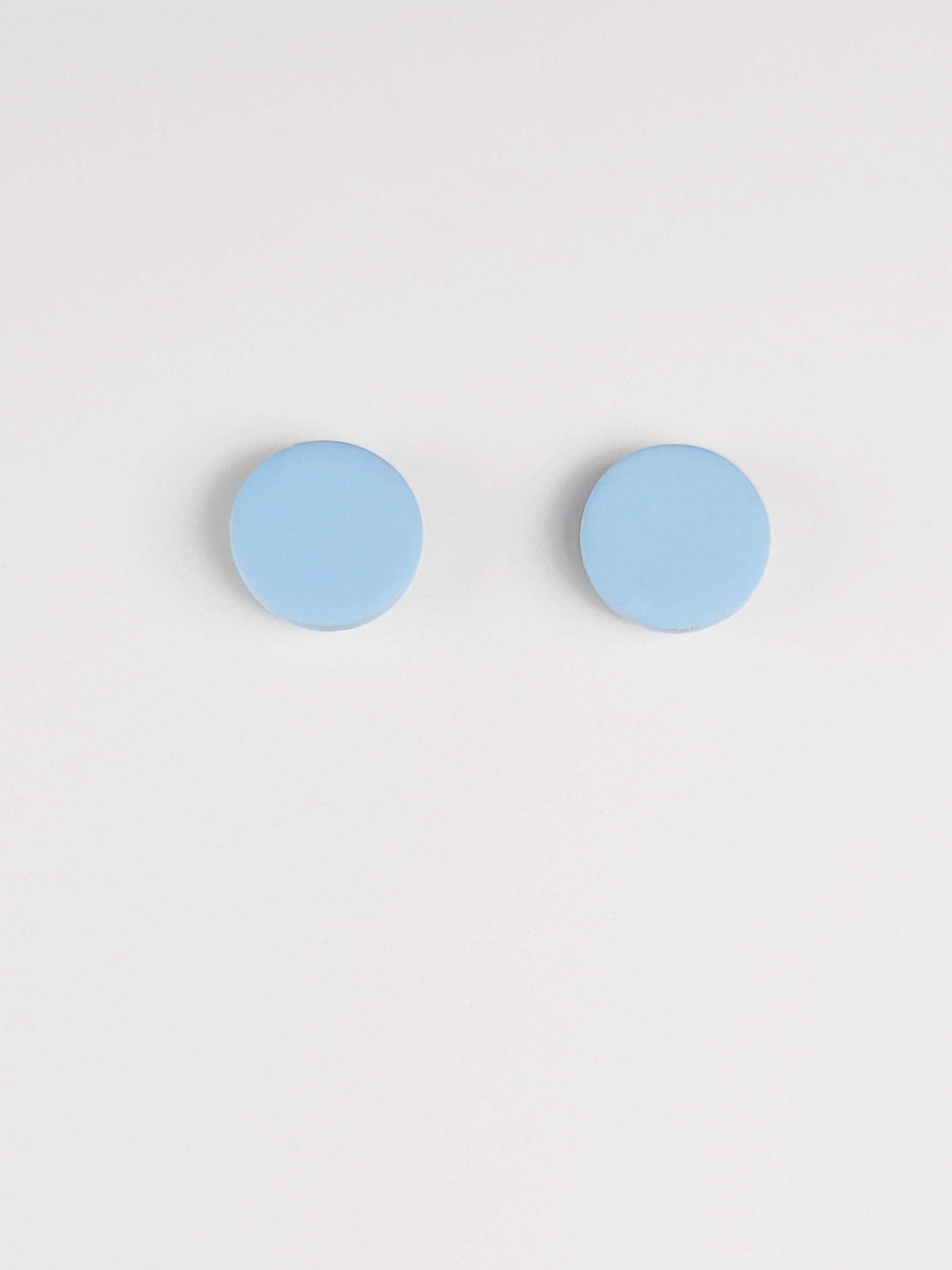 Sky blue round stud earrings made with polymer clay and sterling silver available in 6, 9, 13 or 16 mm diameters.