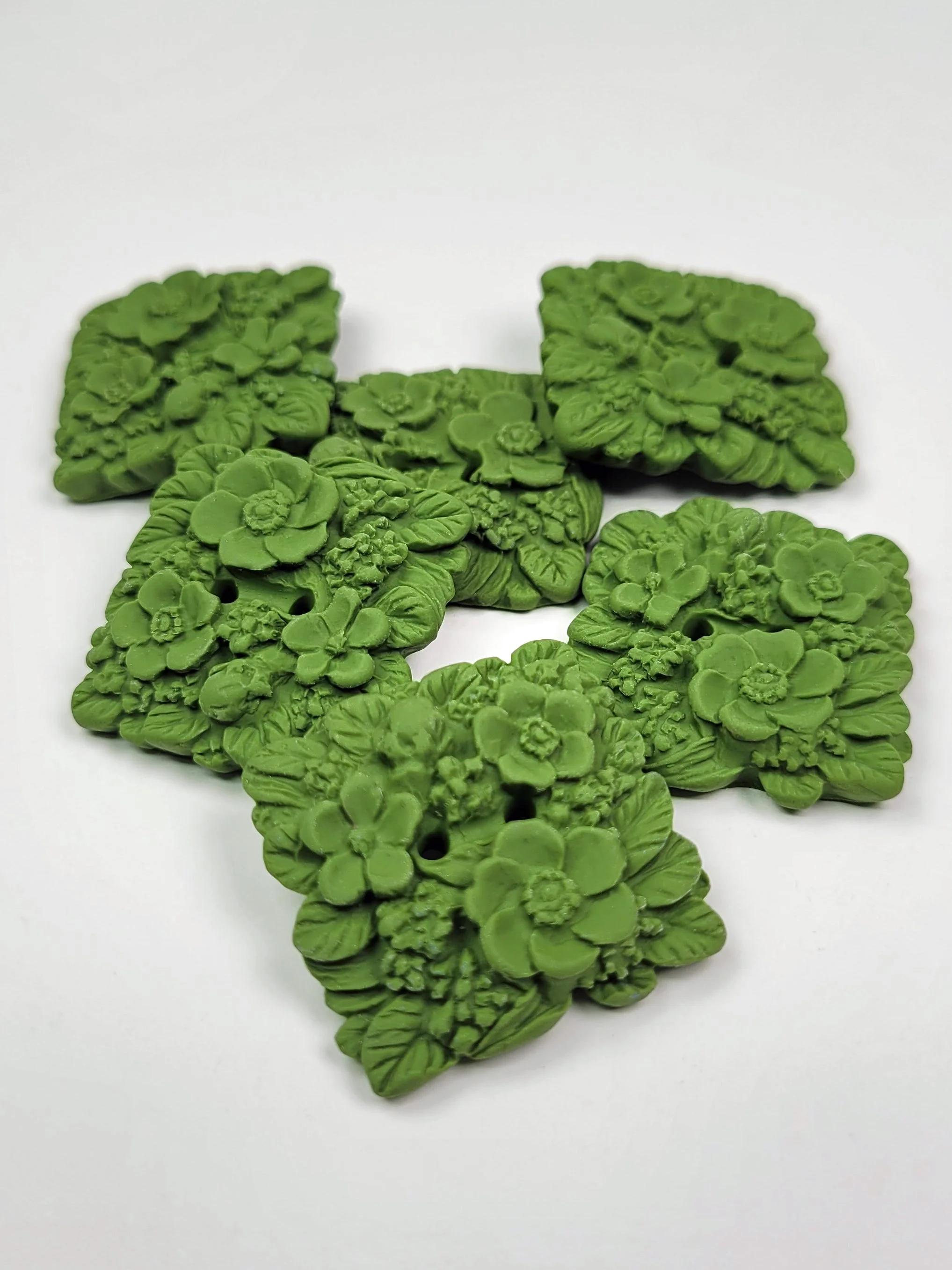 Hand moulded buttons in olive green with three dimensional leaves, flowers and acorns made with polymer clay.