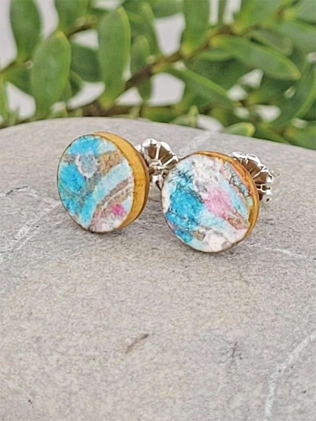 Turquoise and pink studs with ginger brown edges and backs and sterling silver posts and scrolls.