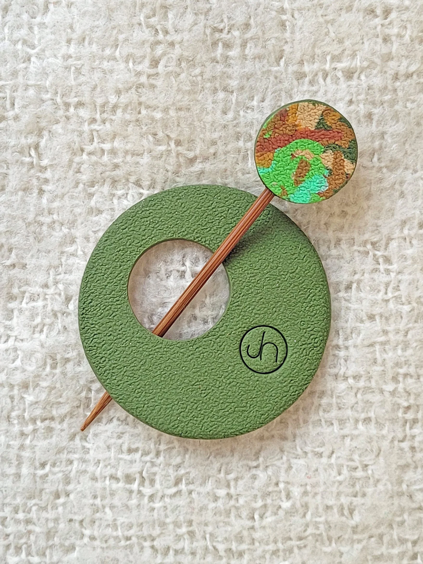 Textured green back of Green Ticker Tape Pin, with colourful round top to the bamboo pin.