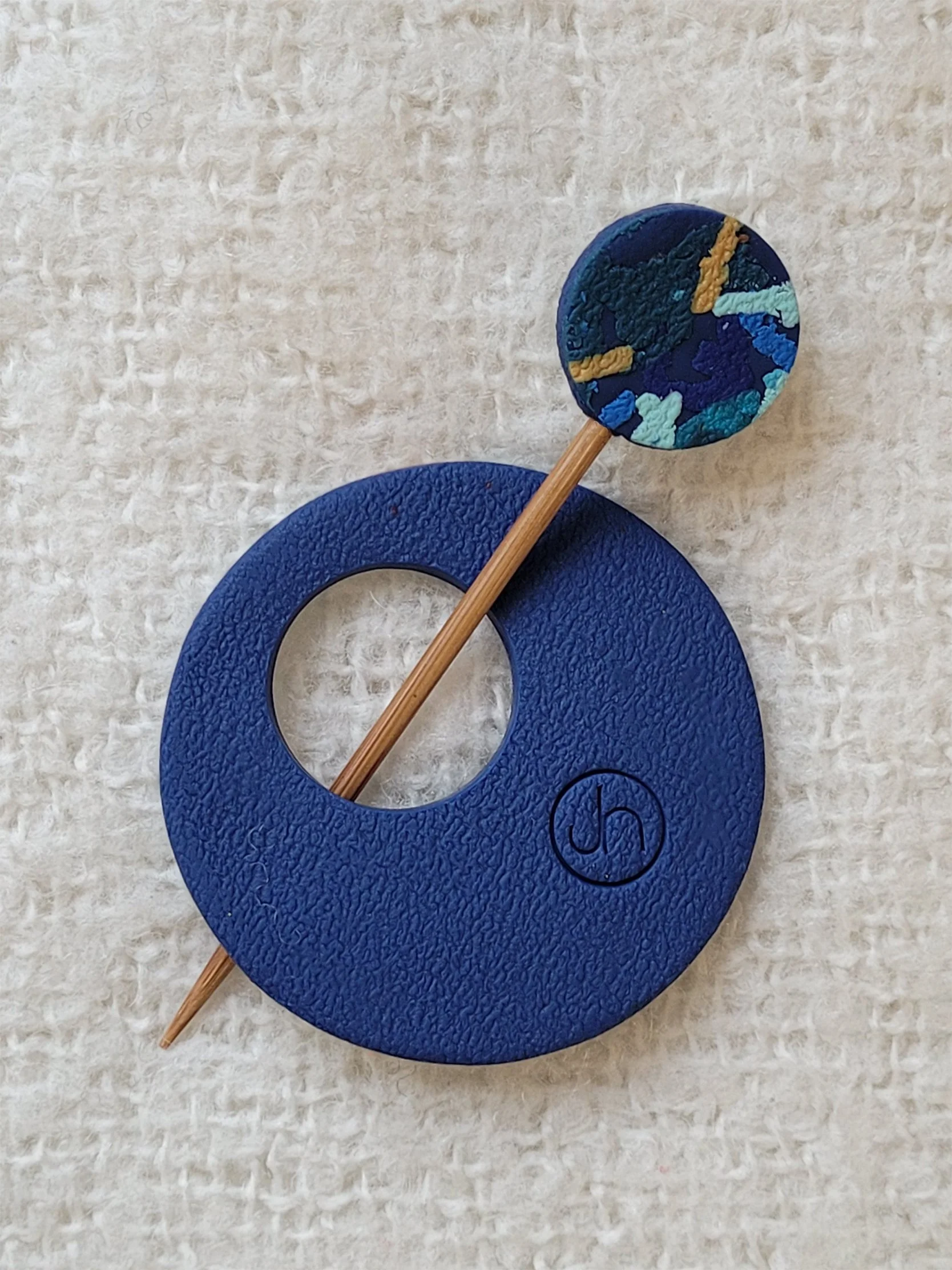Textured navy blue back of Blue Ticker Tape Pin, with colourful round top to the bamboo pin.