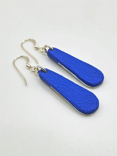 Back view of teardrop earrings showing textured cobalt blue polymer clay, with sterling silver earwires.