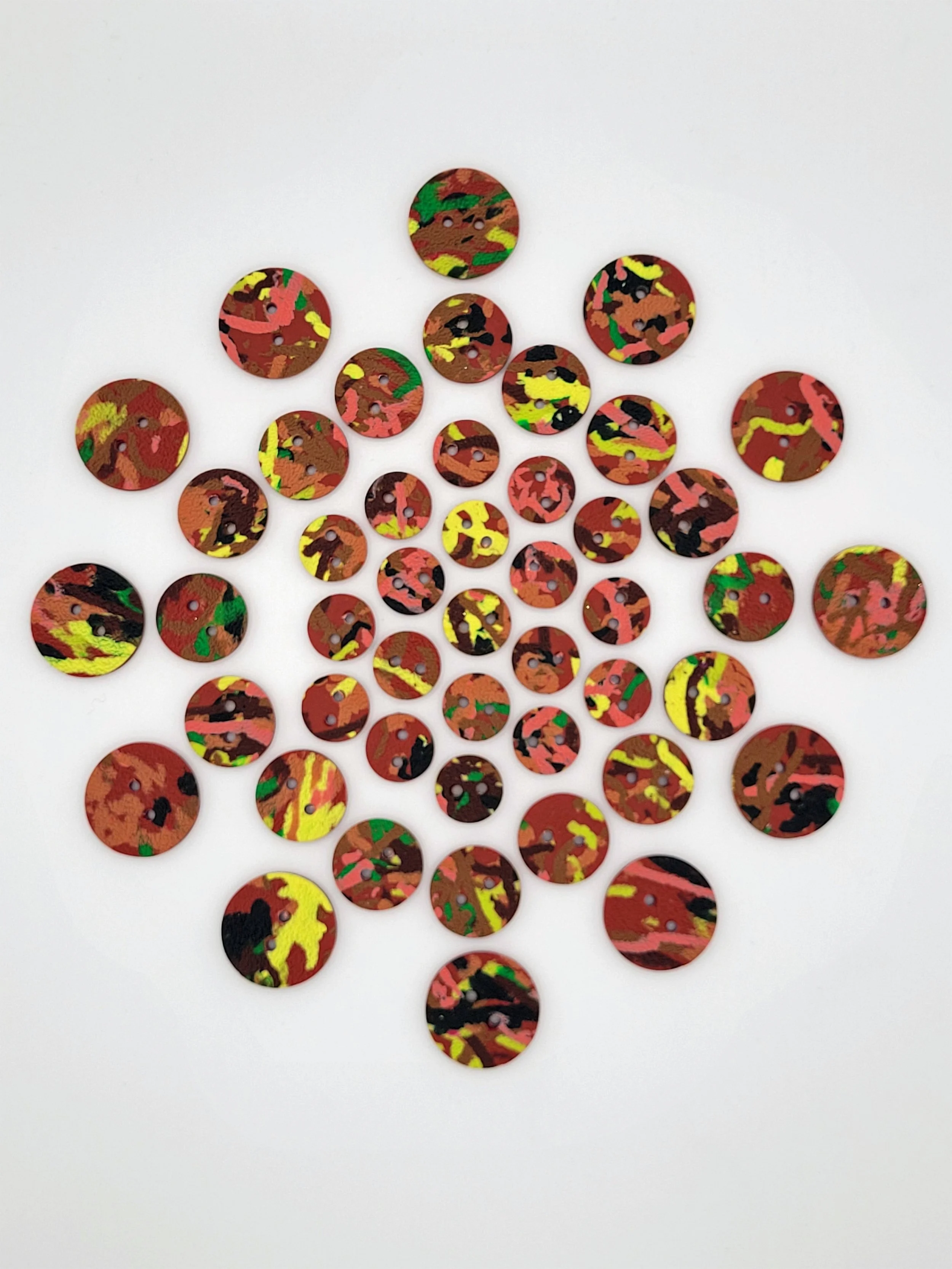 Aerial view of Terracotta Ticker Tape buttons arranged in a circle with the smallest in the middle, getting bigger towards the outer edge of the circle.