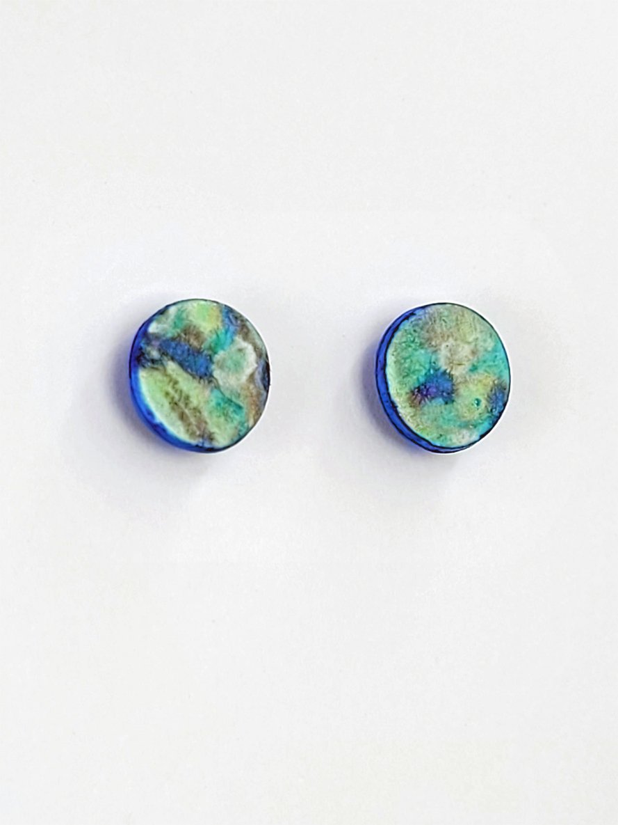 Stud earrings with subtle blue, green and turquoise faces and irregular cobalt blue edges.