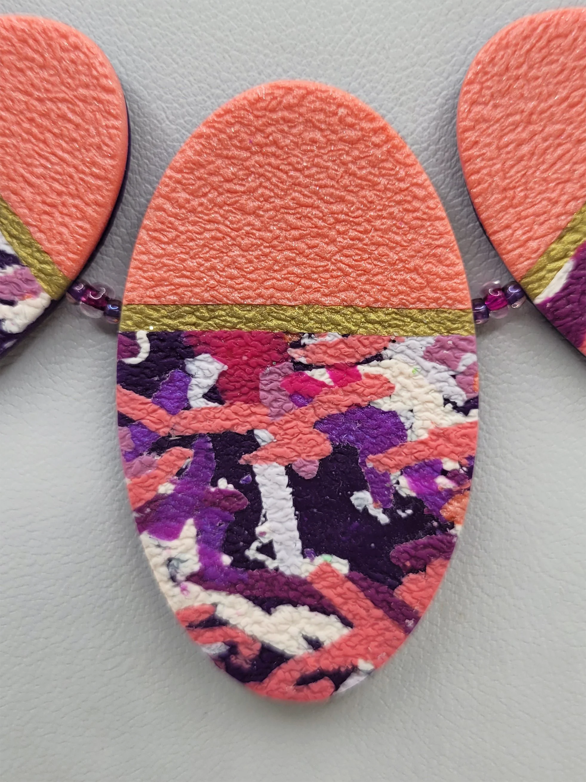 A close up of the pink and purple centre bead showing a detail of the intricate pattern and texture.