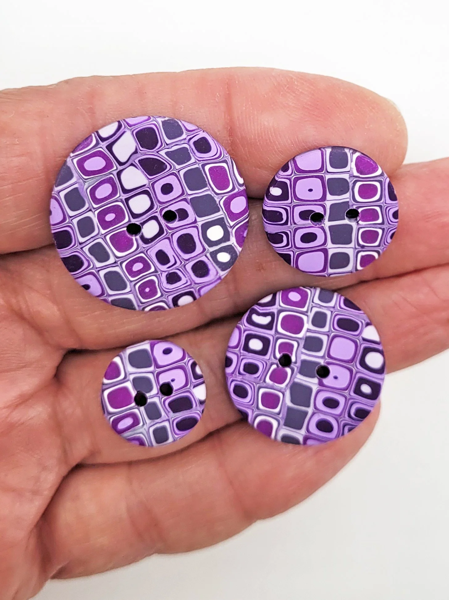 Klimt inspired red, orange and yellow buttons in four different sizes.