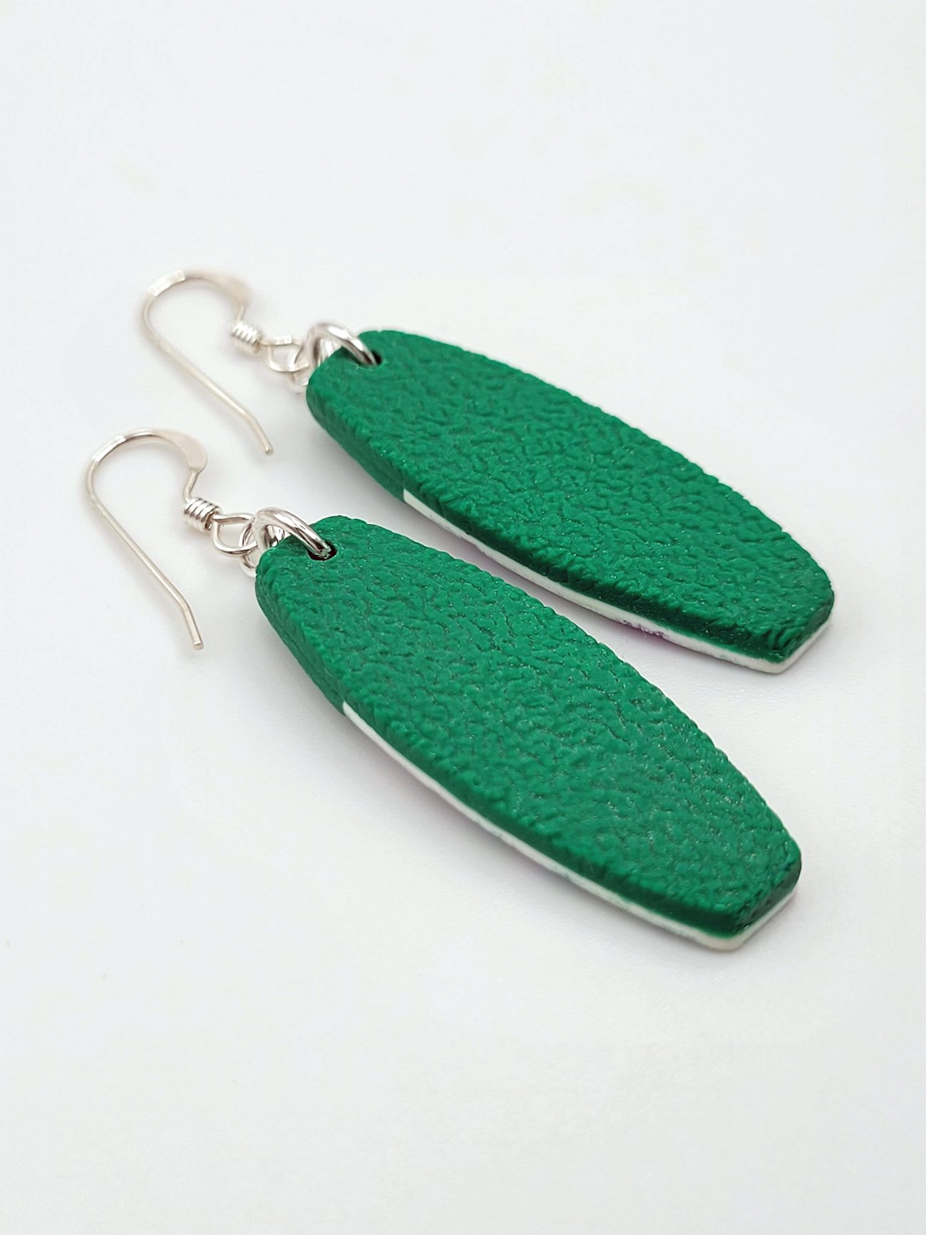 Back view of tablet earrings showing textured green polymer clay and sterling silver earwires.
