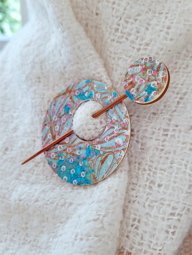 Contemporary, round disc and pin shawl fastener in shades of pink, turquoise, ginger and white.