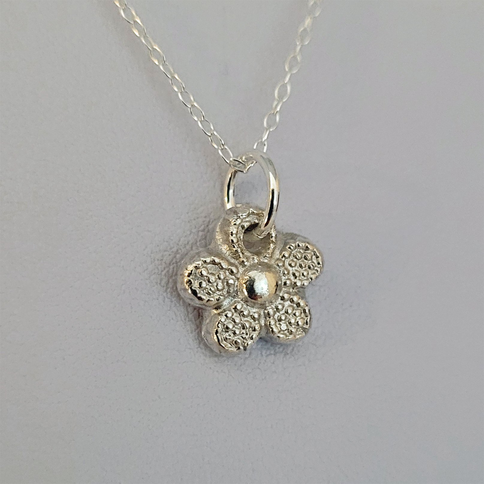 A graphic style daisy pendant made by Sue on a Silver Clay Jewellery for Beginners workshop.
