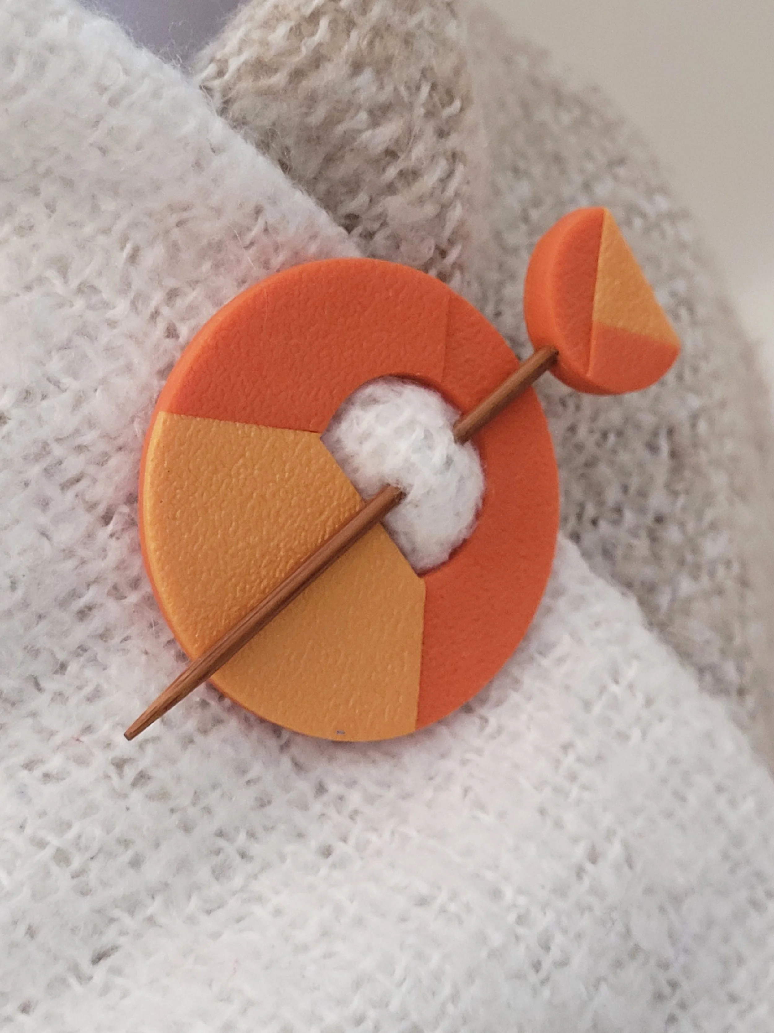 The Two Tone Orange pin features a pearlescent lower left quadrant and two cut layers of the darker tone.