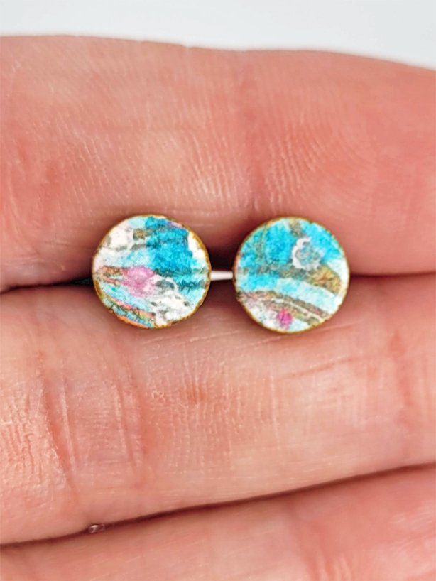 Sprig Ginger Studs held between fingers to highlight their size.