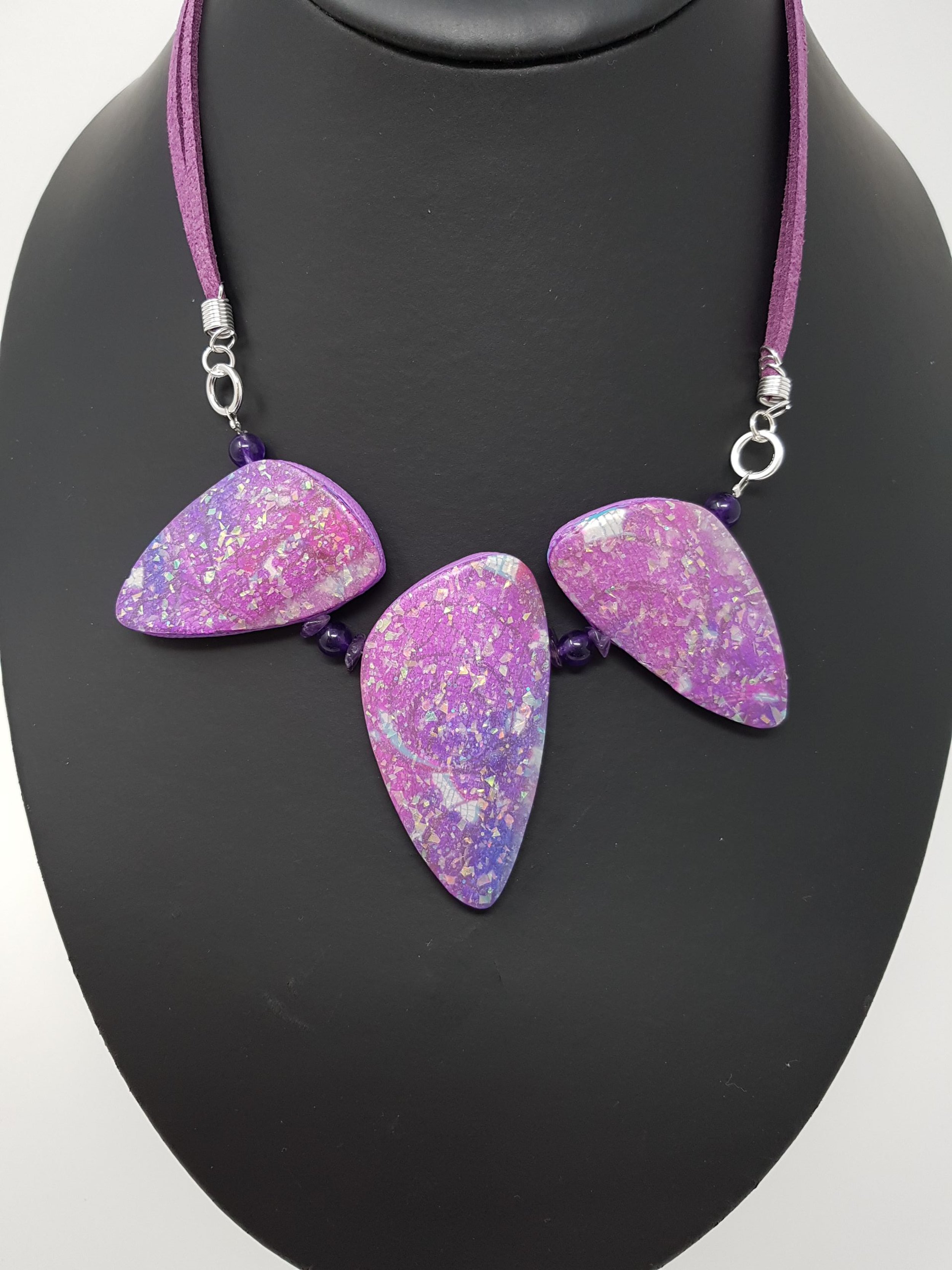 A necklace with 3 abstract shimmer and sparkle technique beads.