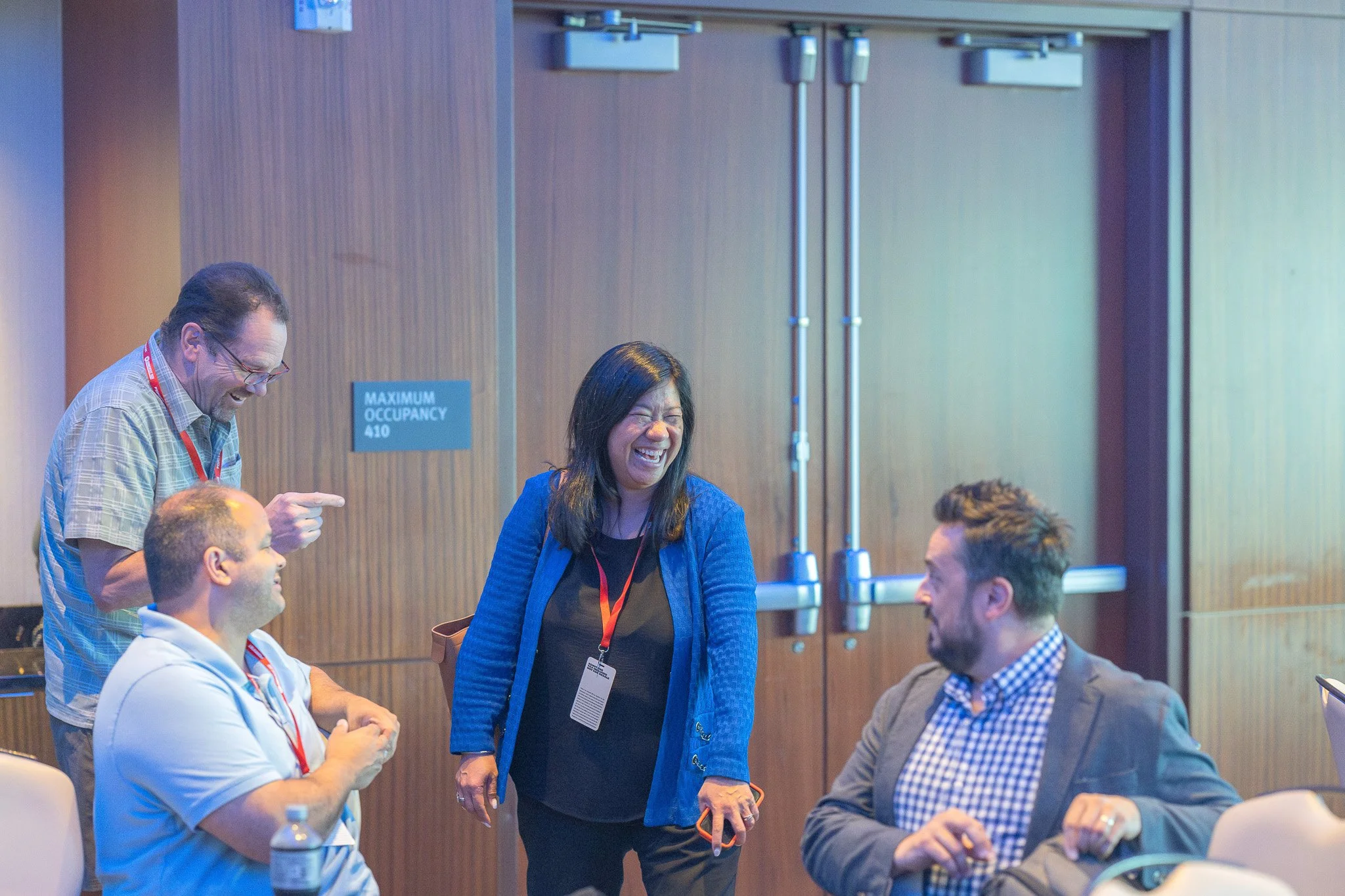 Colleagues share a genuine laugh during a break at a corporate event in Milwaukee