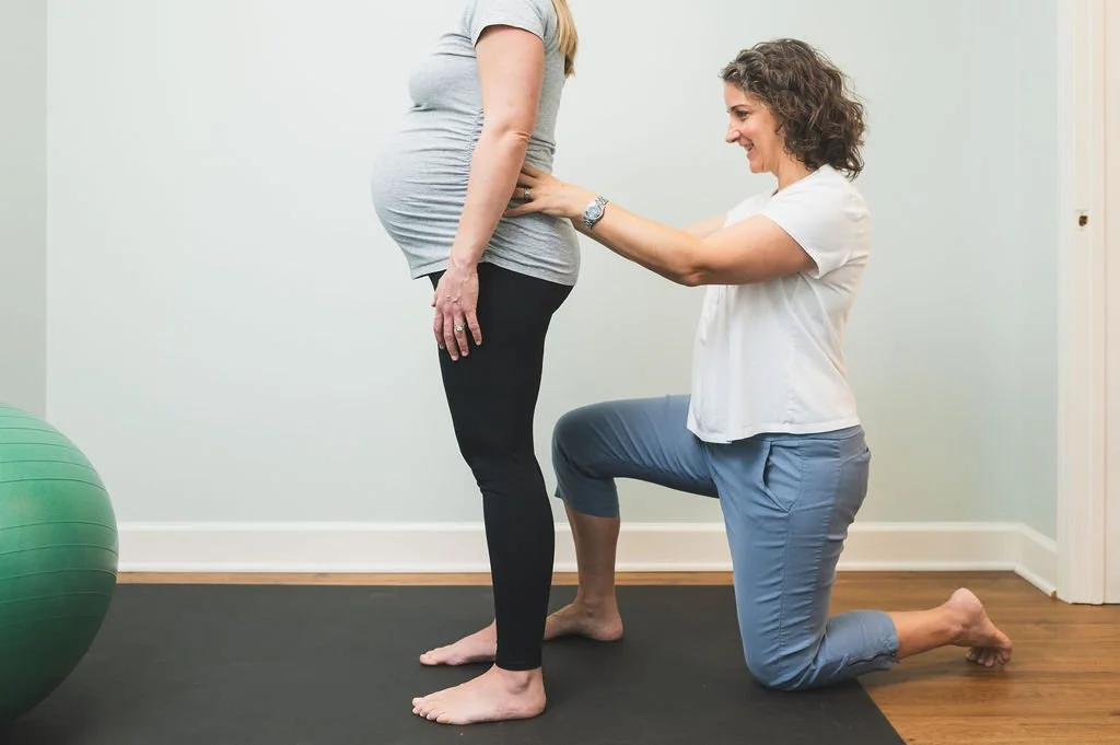 Amanda Shipley checks a pregnant patient's alignment at Renew Pelvic Health in Decatur GA