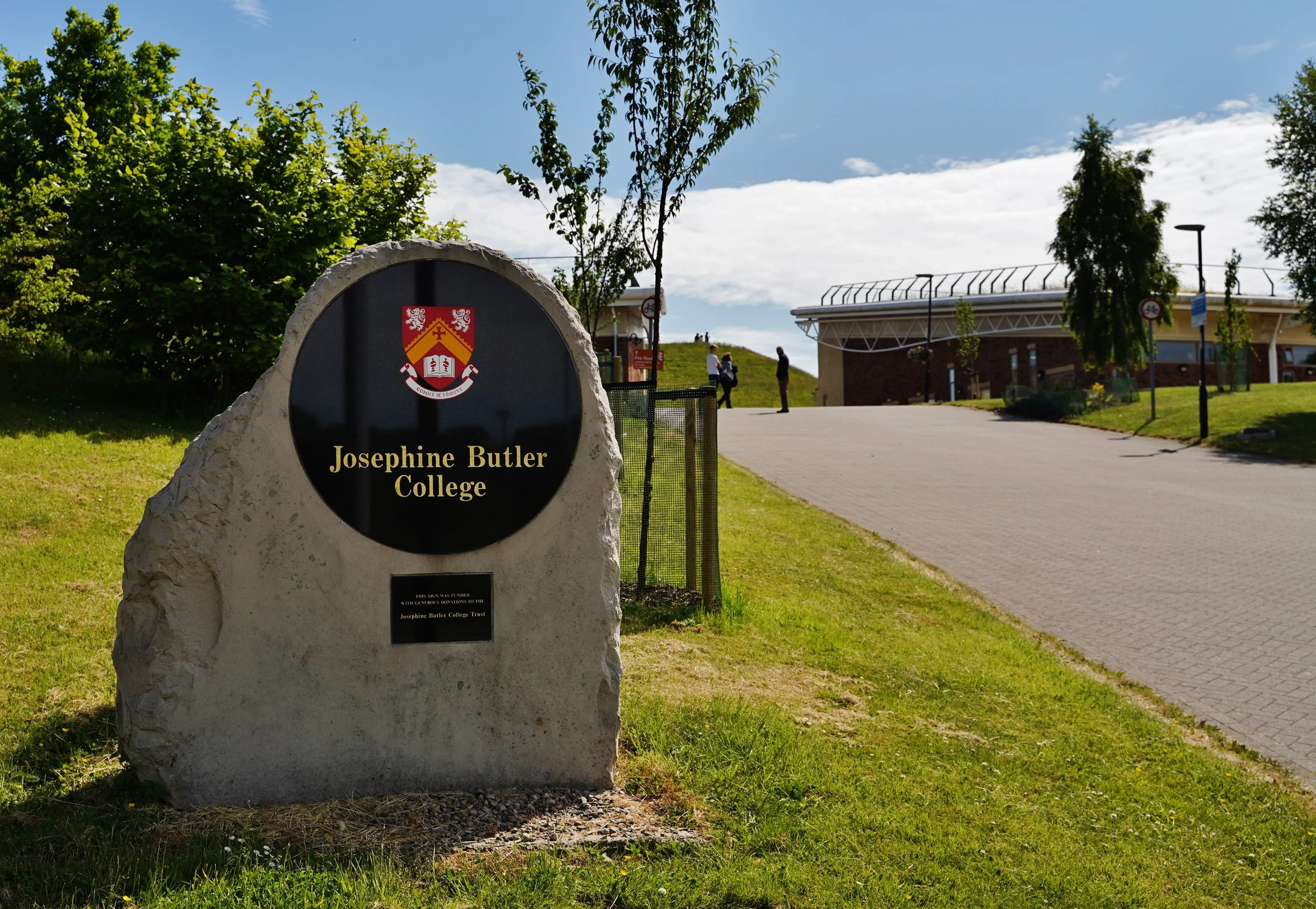 A view of the driveway to Josephine Butler College, with the college sign in the foreground